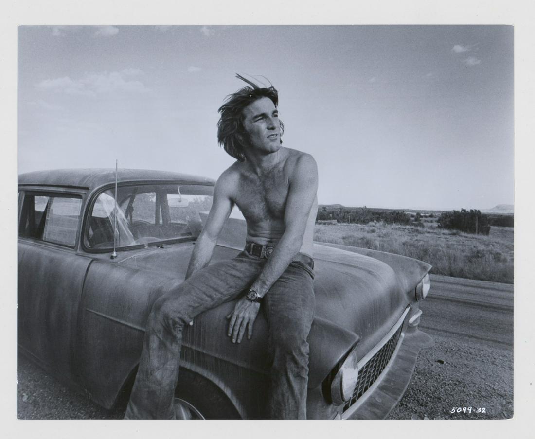 Dennis Wilson in Tow-Lane Blacktop Photo: Dennis Wilson in Two-Lane Blacktop original publicity photo. Measures 9.5-in. x 7.5-in. Glossy, black and white photos on single-weight paper. EX condition. Provenance: Formerly the personal collectio