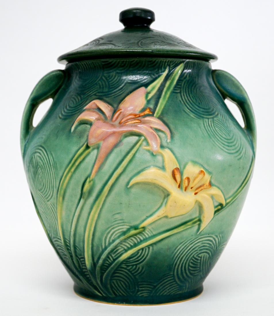 Green Zephyr Lily Cookie Jar: Roseville Green Zephyr Lily cookie jar. Excellent condition with no chips, cracks or repairs. Measures 10.25-in. x 7.5-in. If lot is absent of a condition report a condition report may be requested vi