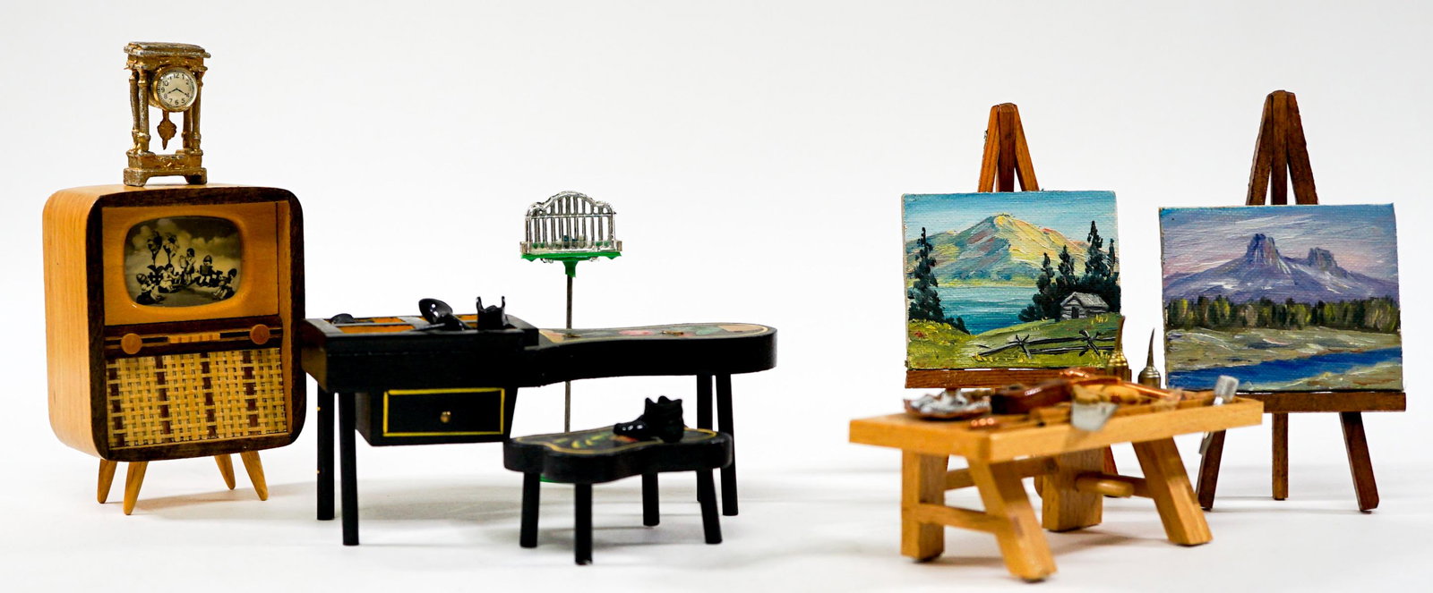 Dollhouse Miniatures Vintage: Collection of vintage dollhouse miniatures. Includes: 1) Television. 2) Bird House. 3) Clock. 4) Two easels with paintings. 5) Work bench with tools. 6) Cobblers bench with shoes. Provenance: Private