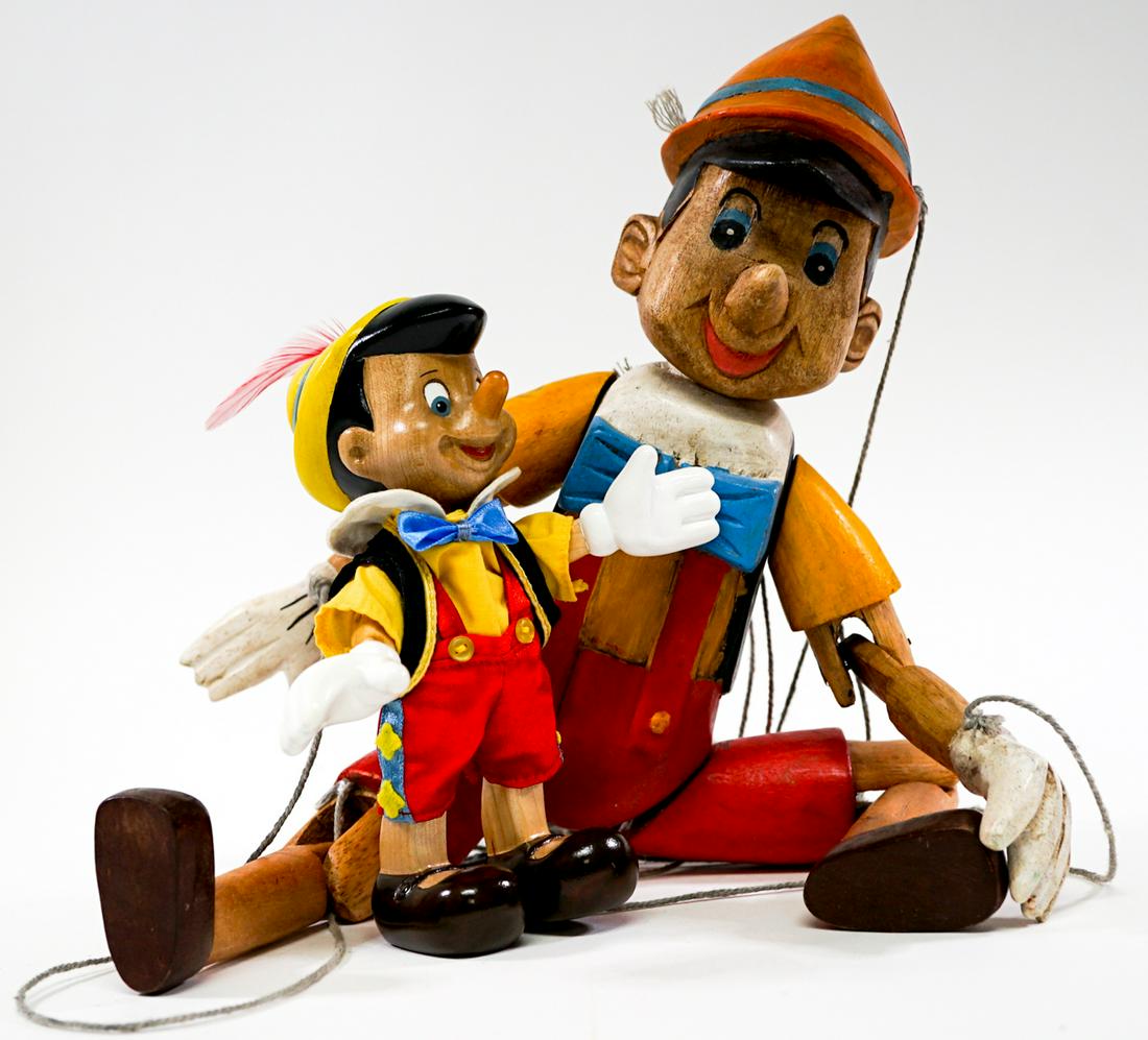 Pinocchio (2) Dolls: Two Pinocchio dolls. One marionette wood carved and hand painted. Measure 6.5 in. and 16 in. Provenance: Private Collection Missoula, Montana. If lot is absent of a condition report a condition report