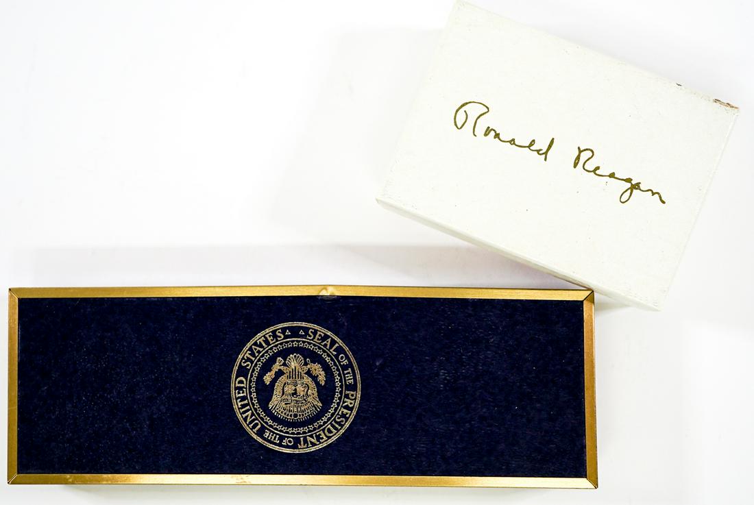 Ronald Reagan Keychain; Pen and Pencil Set: Presidential Seal Ronald Reagan keychain; and pen and pencil set. Mint in box. Provenance: Estate of former United States of America government employees, gifted while serving at The White House. If l