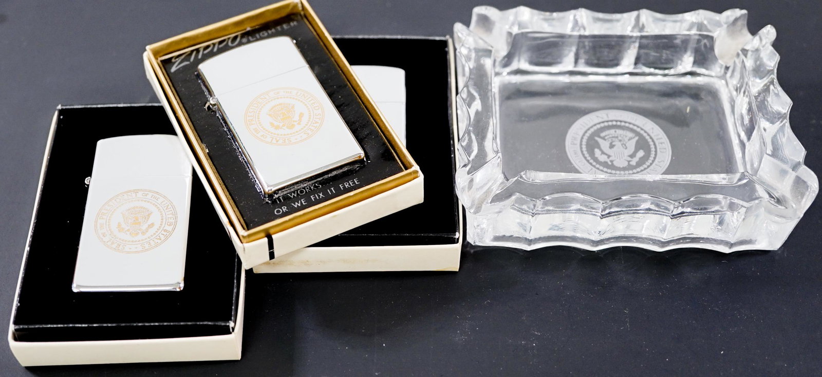 Vintage Presidential Seal Ashtray and (3) Lighters: Presidential Seal vintage glass ashtray and three 'ZIPPO' lighters in box. Ashtray measures 3 in. x 4 in. Provenance: Estate of former United States of America government employees, gifted while servi