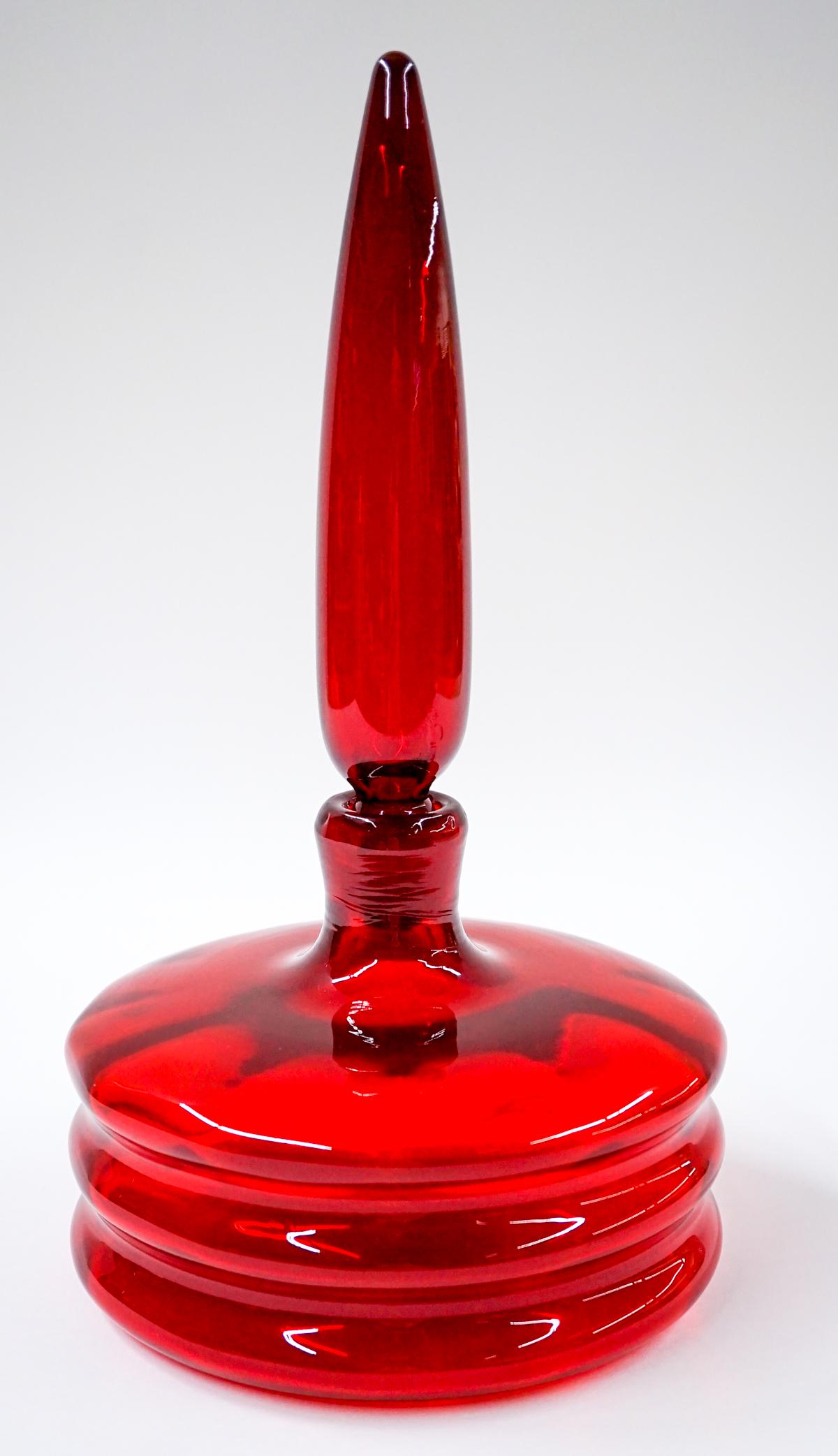 [Blenko] Mid-Century Glass Decanter: Blenko (or other maker) mid-century glass regal ruby red decanter. Wayne Husted. Measures at base 7.75 in. diameter with at total height of 14.5 in. No chips, cracks or repairs. Provenance: Tri-Cities