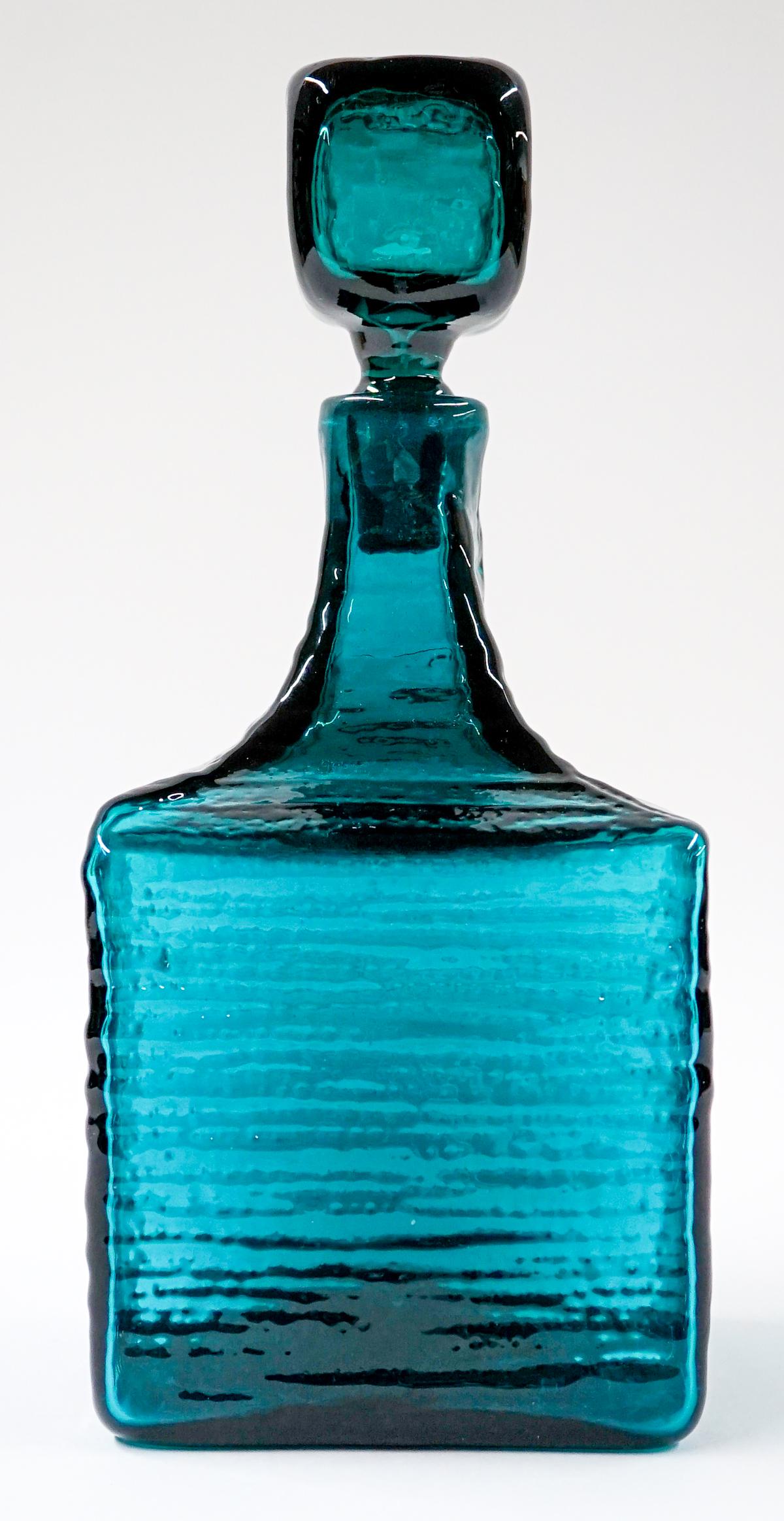 [Blenko] Mid-Century Glass Square Decanter: Blenko (or other maker) mid-century glass square textured teal decanter. Wayne Husted #6224. 1962. Measures at base 4.75 in. x 4.75 in. with a total height of 11 in. No chips, cracks or repairs. Prove