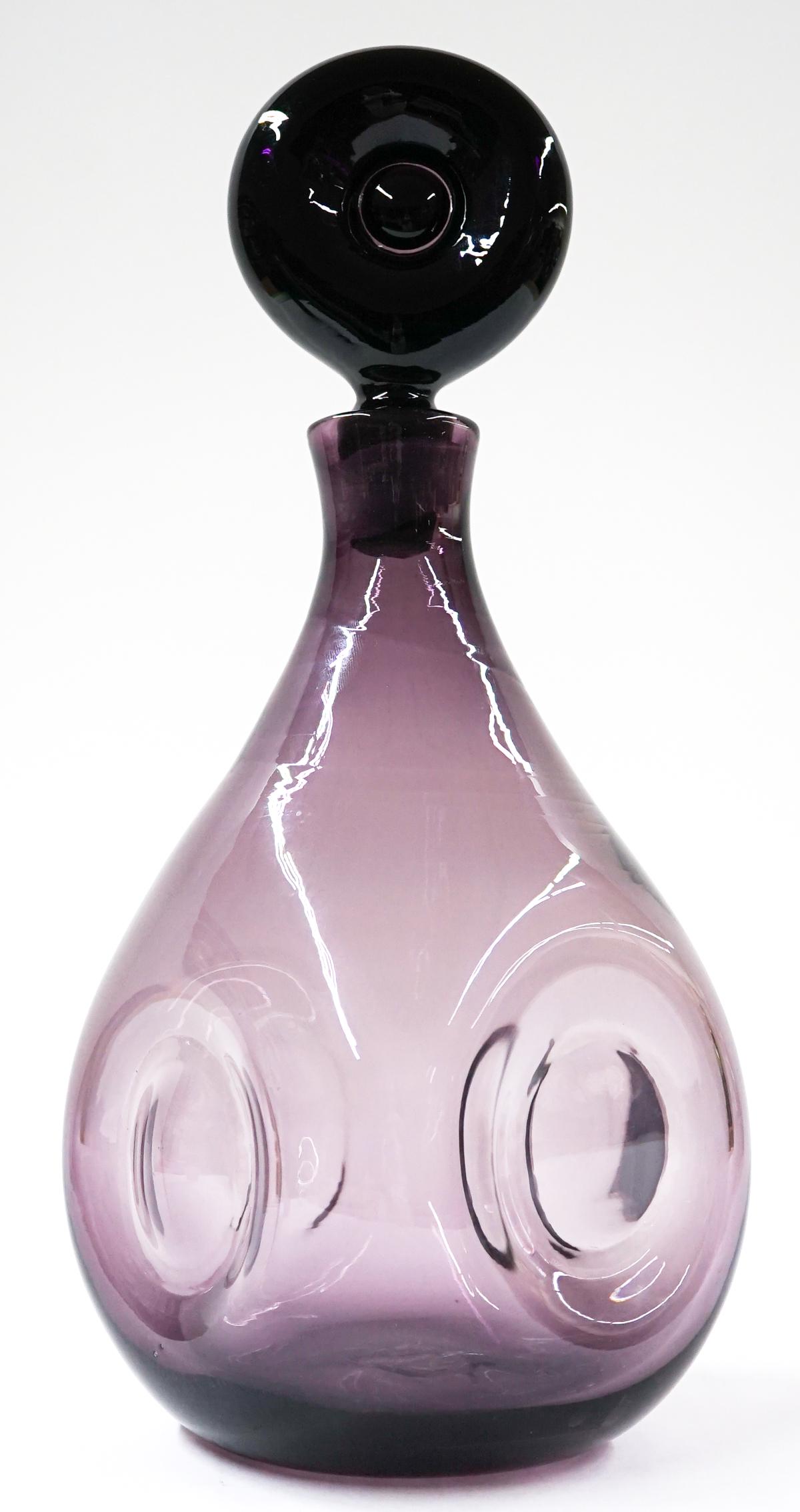 [Blenko] Mid-Century Glass Mulberry Decanter: Blenko (or other maker) mid-century glass mulberry decanter. Wayne Husted #2931. 1958-61. Measures at base 3.75 in. diameter with a total height of 14.5 in. No chips, cracks or repairs. Provenance: Tr