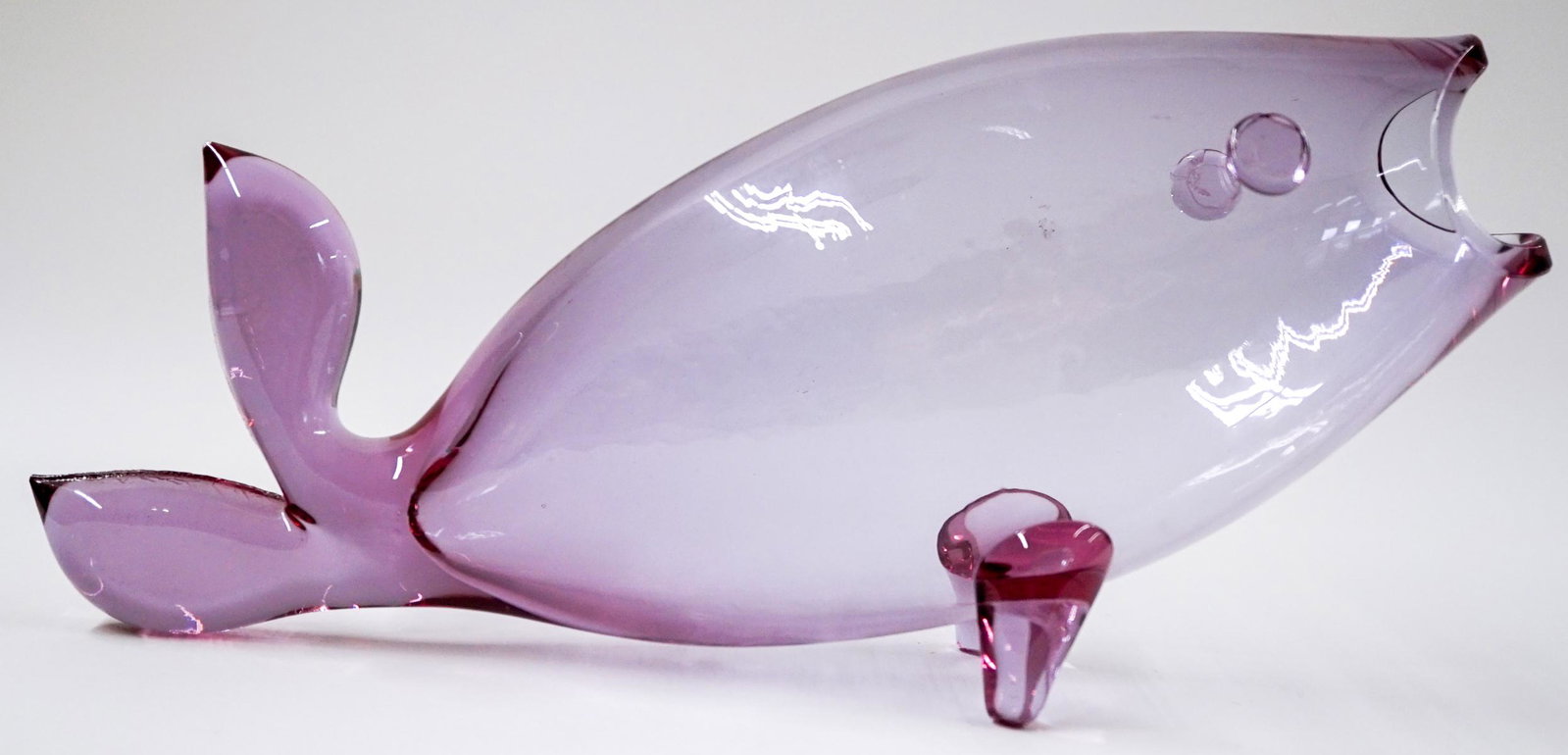 [Blenko] Mid-Century Rose Glass Fish Vase: Blenko (or other maker) mid-century glass rose fish vase. Measures at 17 in. long and 7.75 in. tall. No chips, cracks or repairs. Provenance: Tri-Cities, Washington private collection. If lot is absen