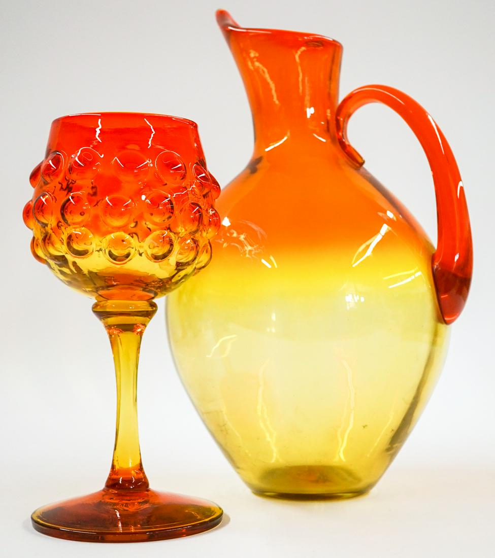 [Blenko] Mid Century Glass Pitcher and Goblet: Blenko (or other maker) mid-century glass pitcher and goblet. Tangerine. Pitcher measures at base 3.75 in. diameter with a total height of 13.75 in.; and the goblet measures 4.125 in. at base x 3.75 i