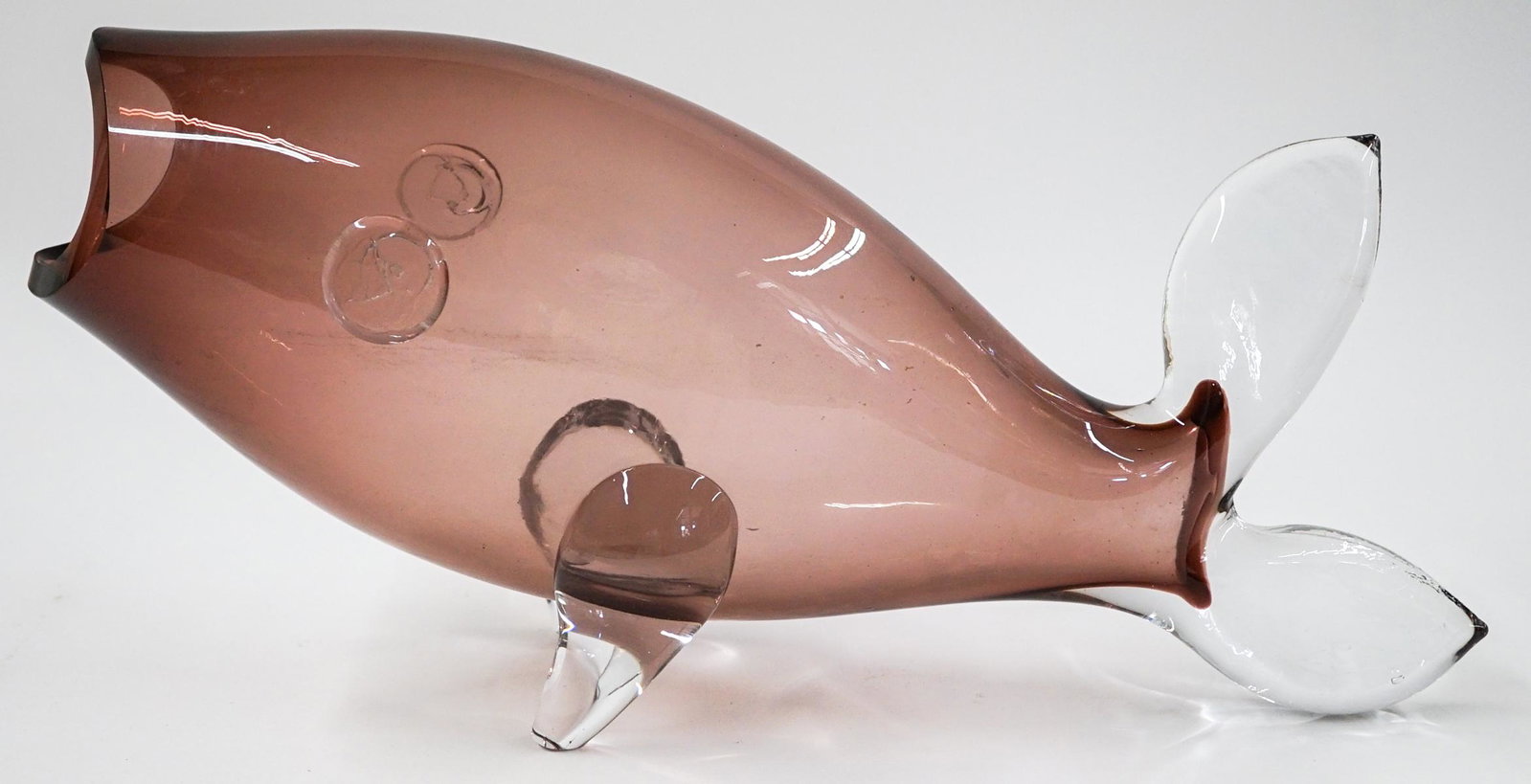 [Blenko] Mid-Century Rose Glass Fish Vase: Blenko (or other maker) mid-century rose glass fish vase. Measures 16.5 in. long and 7.5 in. tall. No chips, cracks or repairs. Provenance: Tri-Cities, Washington private collection. If lot is absent 