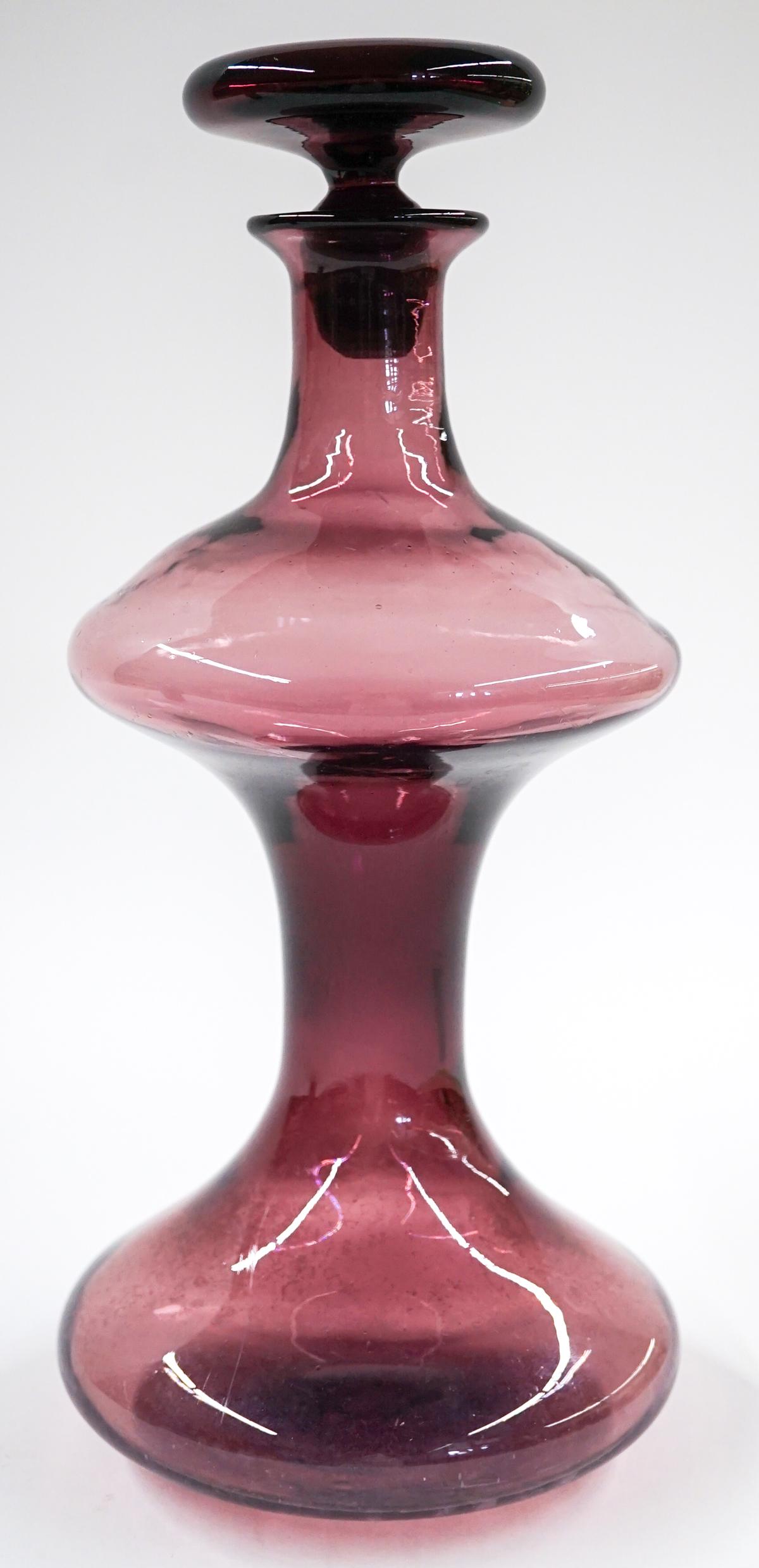 [Blenko] Mid-Century Amethyst Glass Decanter: Blenko (or other maker) mid-century amethyst glass decanter. #563. Measures at base 5 in. diameter with a total height of 13.25 in. No chips, cracks or repairs. Provenance: Tri-Cities, Washington priv