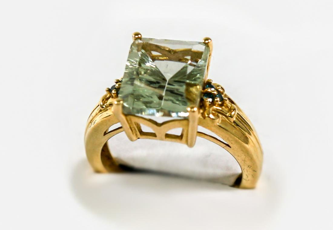Ladies 14K Yellow Gold Tourmaline Ring: Ladies 14k yellow gold colored stone ring weight 3.1 DWT, size 6.5. The ring is set with one fancy emerald cut paraiba tourmaline measuring 10mmx9mm, prong set, with three indicolite tourmalines prong
