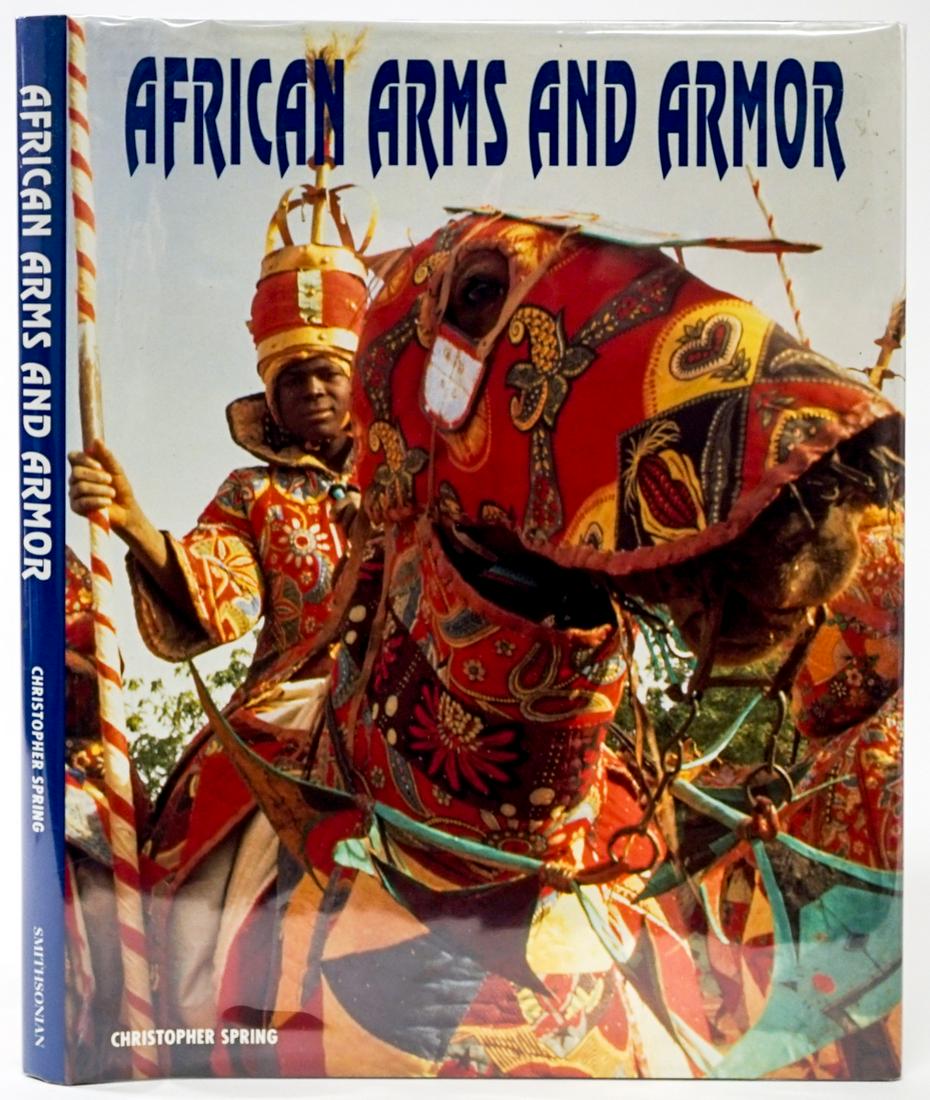 African Arms and Armor by Spring 1993: African Arms and Armor by Christopher Spring. 1993 with dust jacket unclipped. Trustees of the British Museum. 144 pp. Illustrated. Measures 11.125 in. x 8.75 in. x .75 in. If lot is absent of a condi