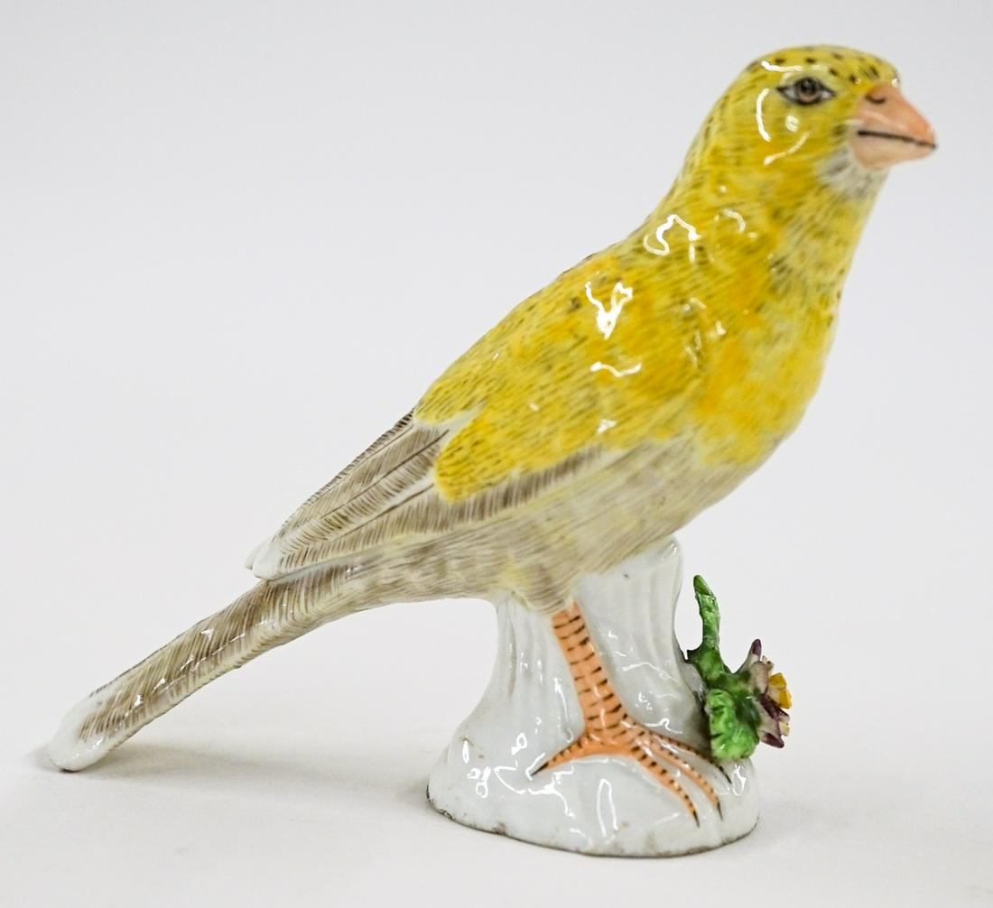 Meissen or Meissen-type Porcelain Bird: Meissen or Meissen-style small porcelain bird figure. Measures 3.5-in. tall. Very good condition with tiny nicks on flowers and small chip on tail feather. If lot is absent of a condition report one m