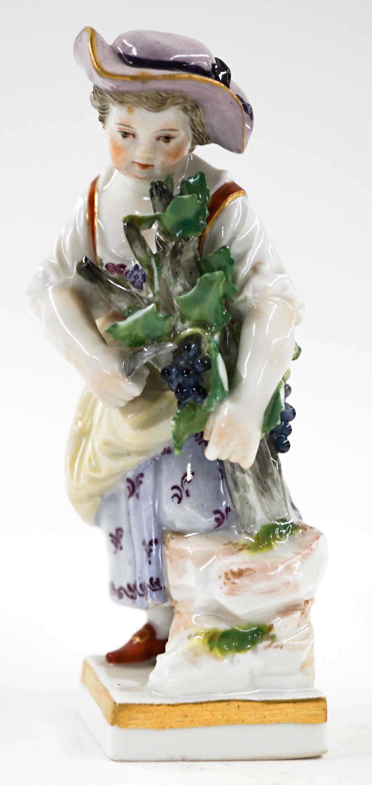 Small Meissen Figure of Girl: A small Meissen figure of a girl. Measures 3.75-in. tall. Has six small chips on leaves she is holding. If lot is absent of a condition report one may be requested via email. Condition report is provi