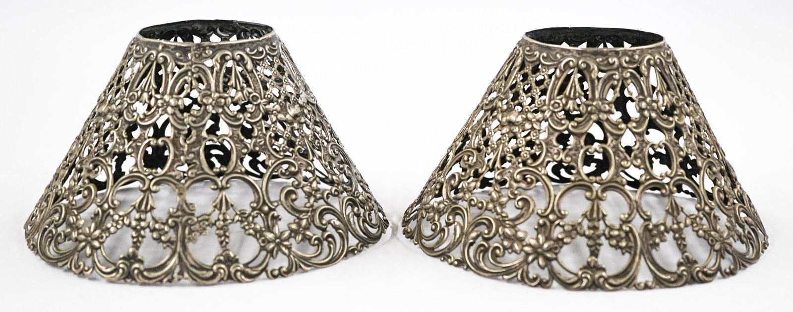 Gorham Pair Sterling Lamp Shades: Gorham pair of sterling lamp shades. They measure 3.25-in. x 5.5-in. weighing 86 grams total. Very good condition. If lot is absent of a condition report one may be requested via email. Condition repo