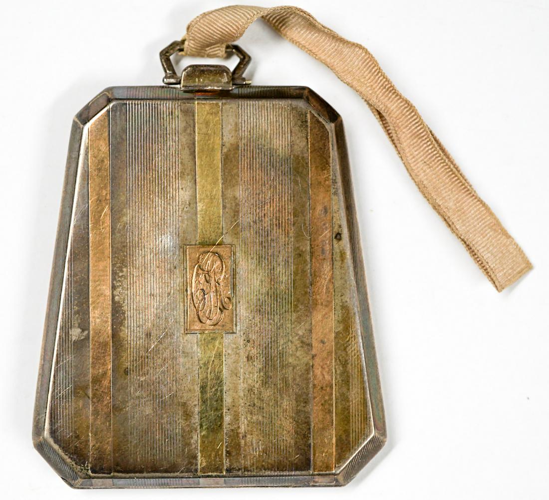 J.E. Blake Sterling and 14k Compact: J.E. Blake and Co. sterling and 14k compact. Measures 2.25-in. x 3-in. Weighs 76 grams. Very good condition. If lot is absent of a condition report one may be requested via email. Condition report is 