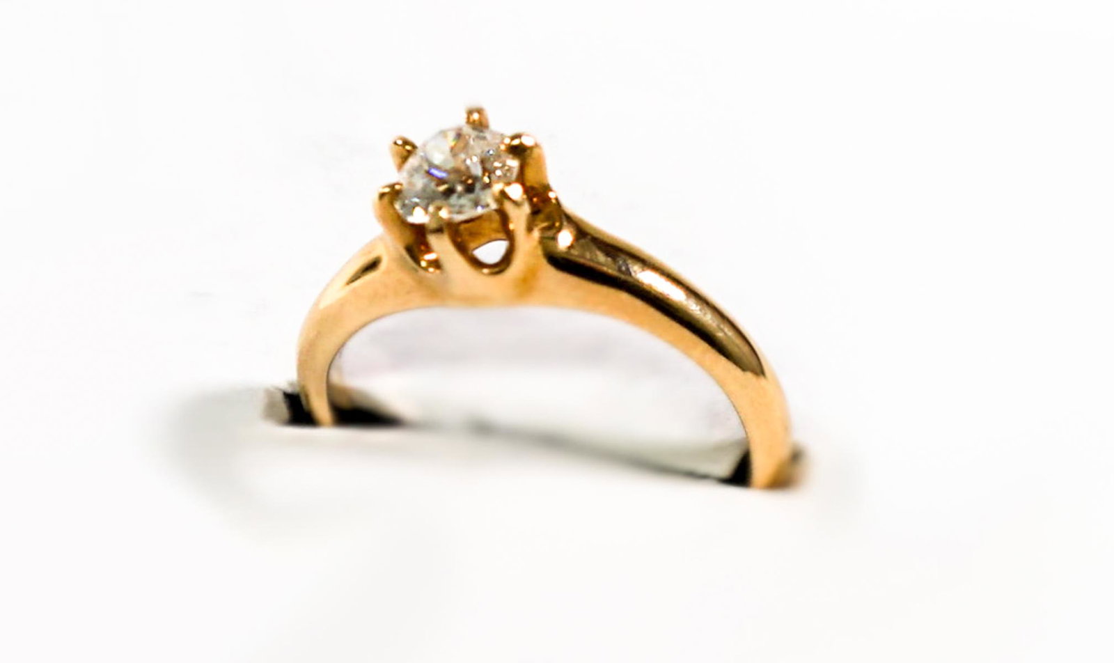 Ladies 14K Gold Diamond Solitaire Ring: Ladies 14k yellow gold diamond solitaire ring weighing .41ct, measuring 4.7mmx4.36mm, graded SI1in clarity and G color. Size 4.5. Set in six yellow gold prongs. Total weight 2.7g. Estimated retail val