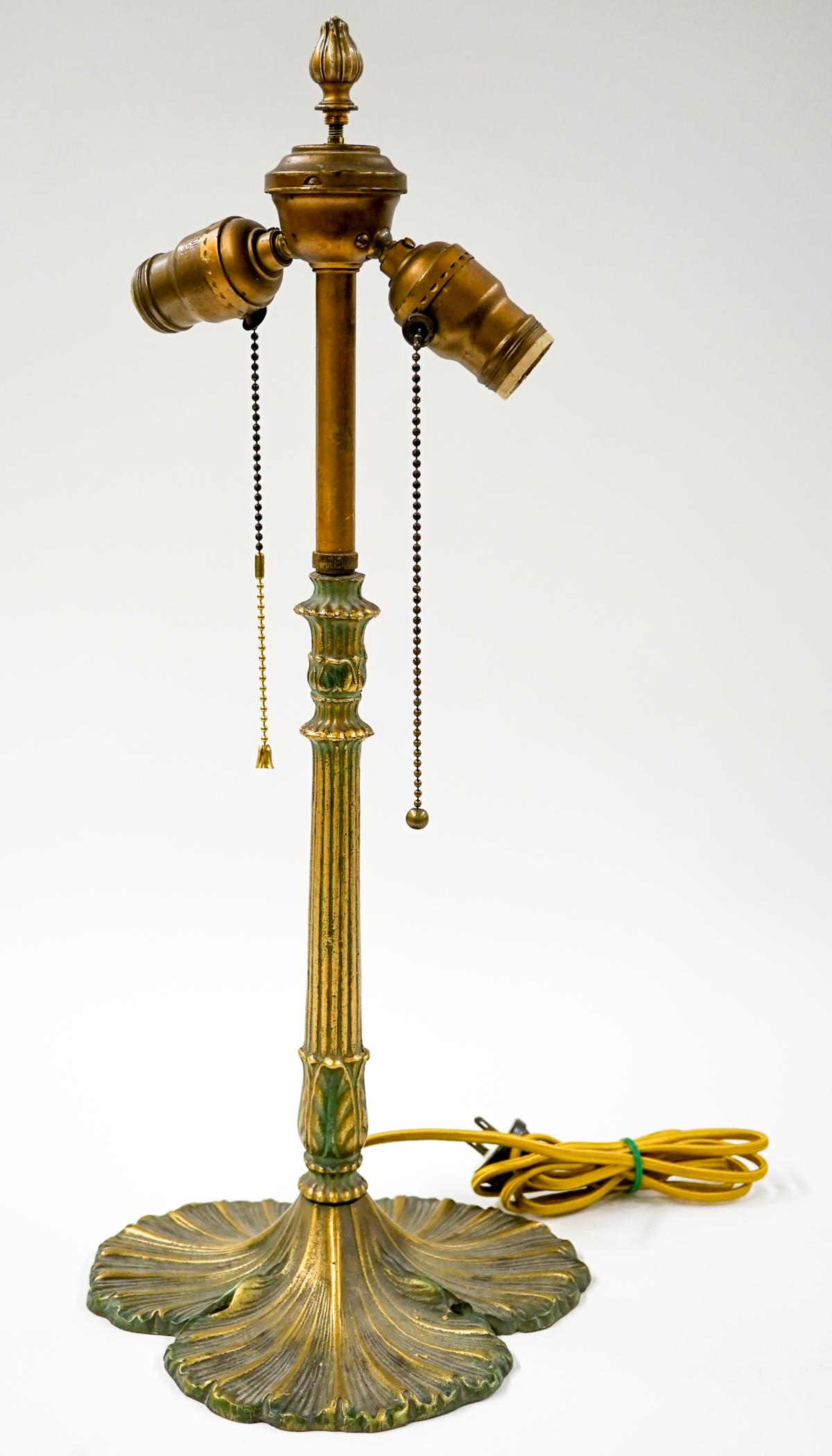 Antique Table Lamp Patina Metal Base: Antique table lamp faux patina metal base with two light fixtures. Total approximate height is 21 in. and base diameter is 9 in. Tested. If lot is absent of a condition report one may be requested via