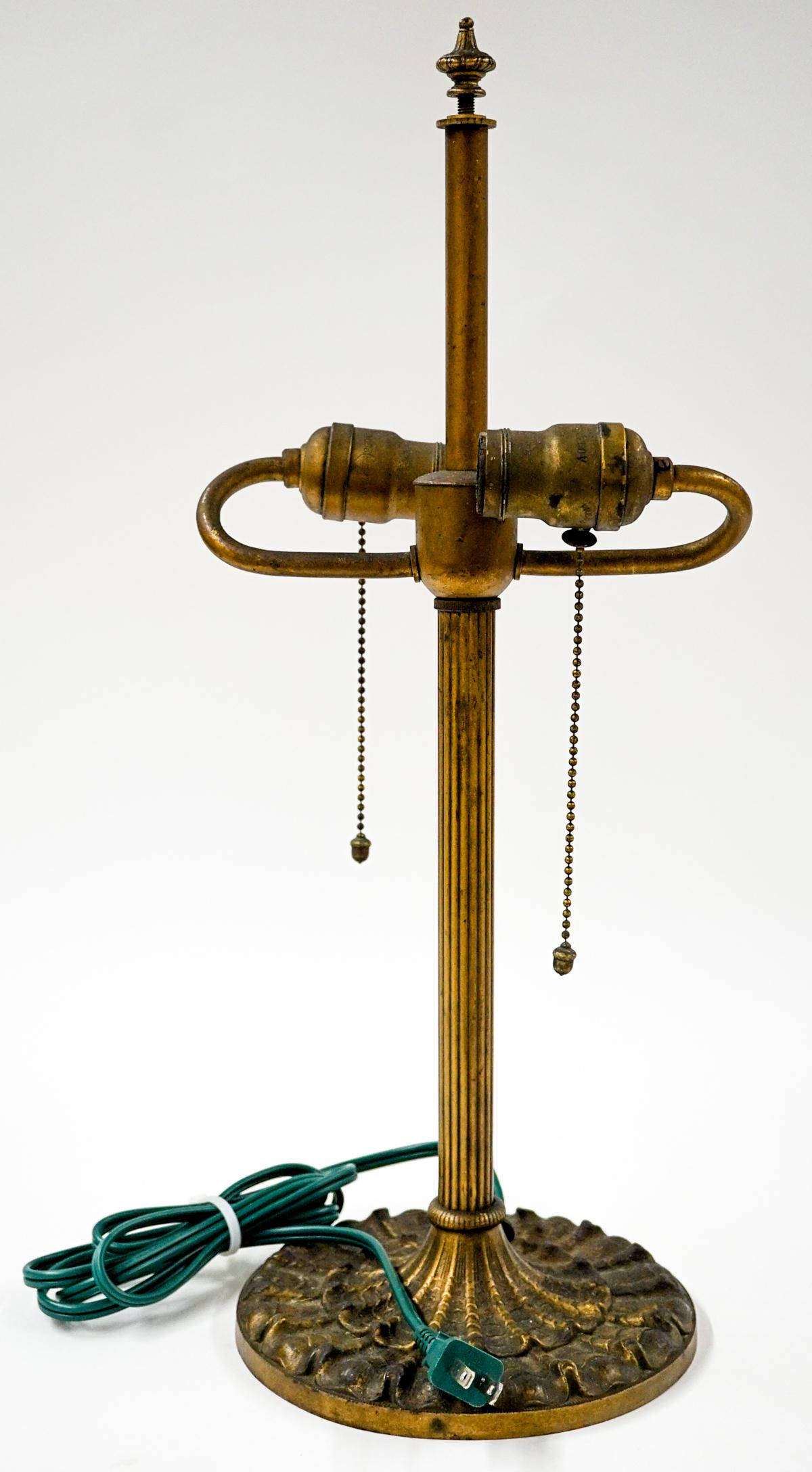 Antique Metal Table Lamp Base: Antique metal table lamp with two light fixtures. Total approximate height is 20.5 in. and the diameter at the base is 7 in. Tested. If lot is absent of a condition report one may be requested via ema