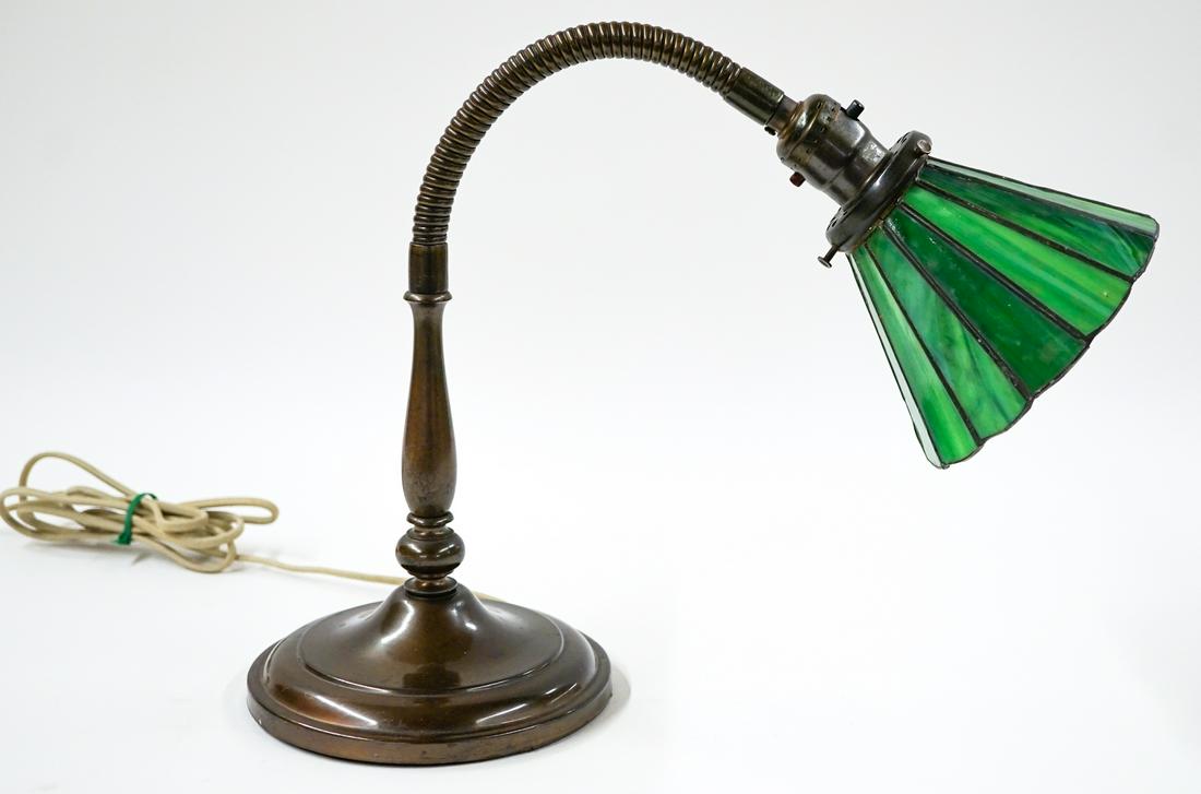 Vintage Table Lamp Leaded Glass Shade: Vintage table lamp with movable arm and leaded glass paneled shade. Height as pictured 14 in. to socket. The shade measures 6 in. diameter. Tested. If lot is absent of a condition report one may be re