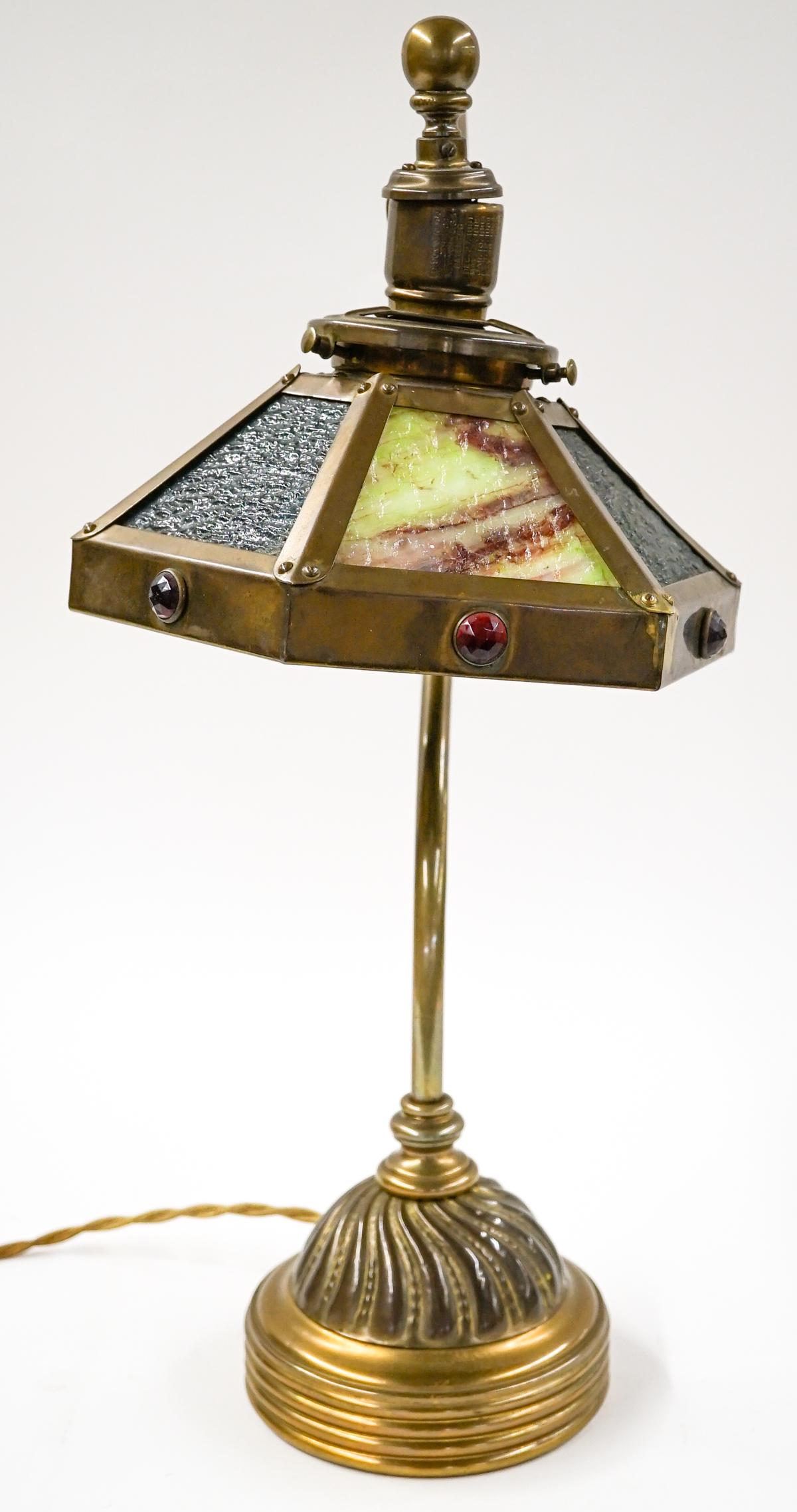 Vintage Brass and Stained Glass Lamp: Vintage brass and stained glass lamp. Six panels. Total height 20.5 in. with a base diameter of 6 in. Shade measures 9 in. across rim. NOT Tested, needs socket repair. If lot is absent of a condition 