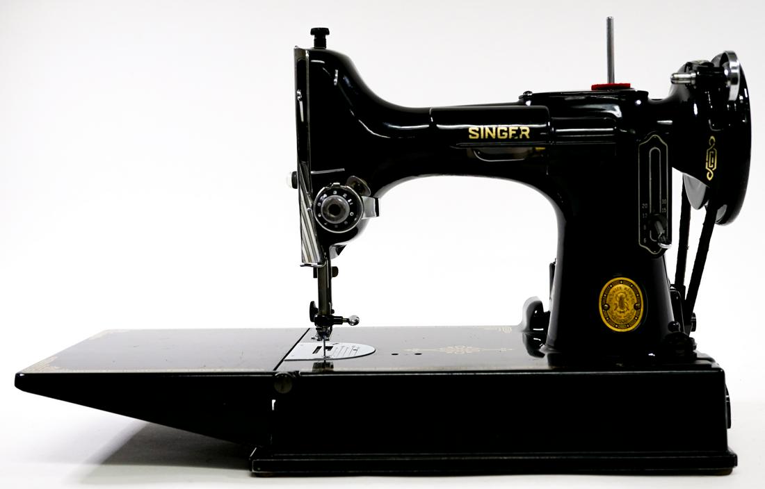 Singer Featherweight Sewing Machine: Singer Featherweight sewing machine. Excellent condition. With case, Serial number AL407080. Weighs 18lbs, outside case measures 12x14.25x8.25". Outside shipper or buyer pick-up required on this item.