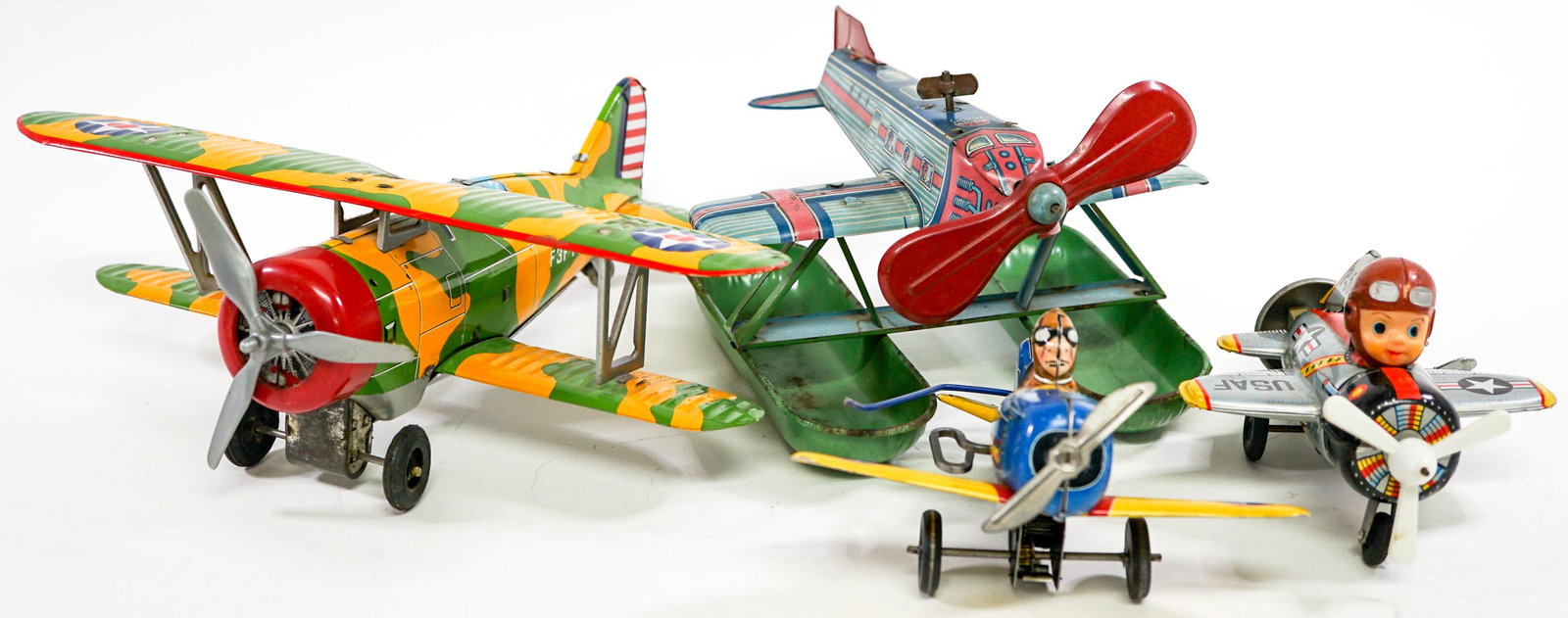 Vintage Tin Metal Toy Planes (4) Mar and Others: Collection of four vintage tin metal toy planes. The three wind-up have been tested and one is marked 'MAR'. One is battery operated and has not been tested. Measure approximately 5 in. - 10 in. long.