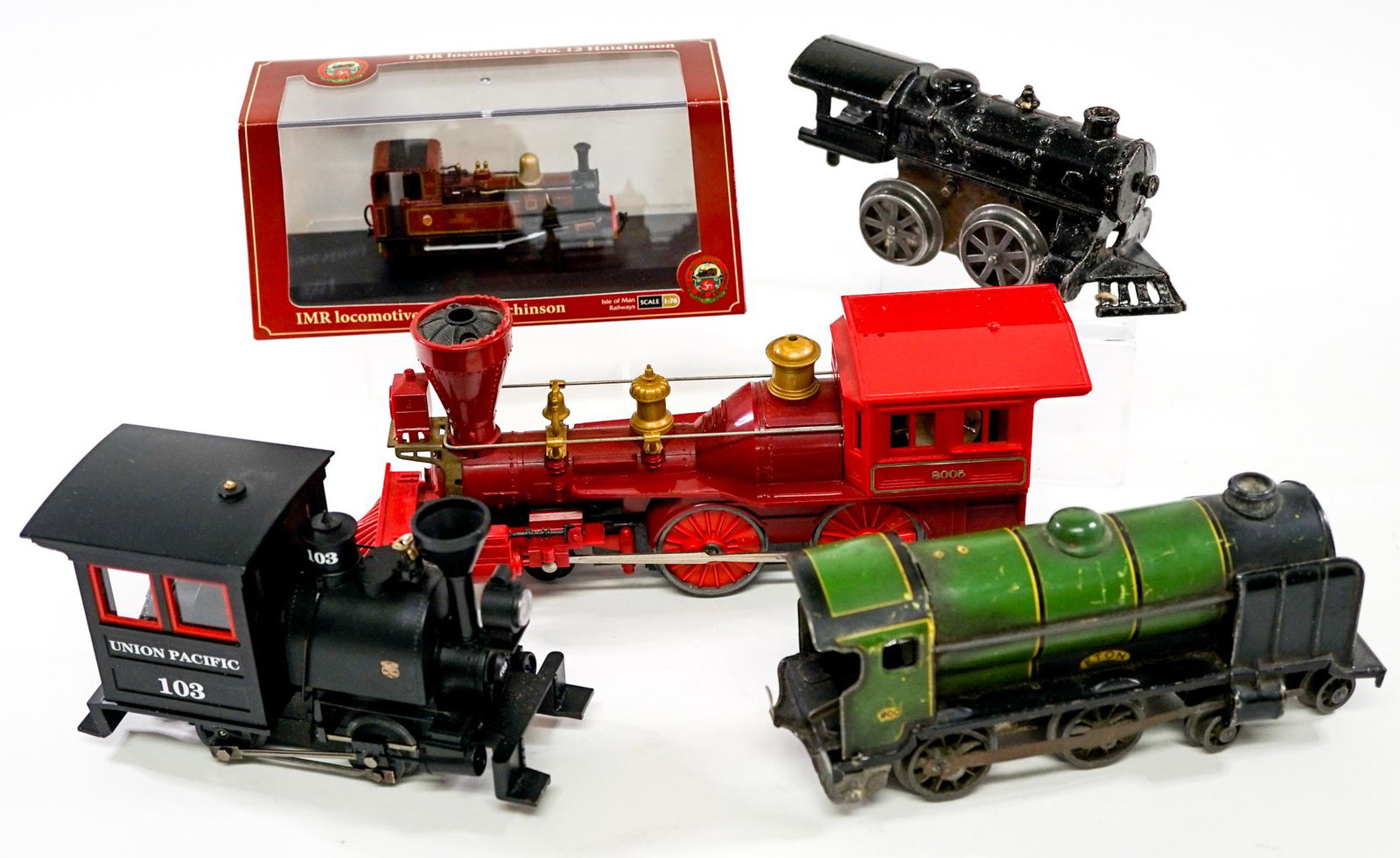 Vintage Toy Train Engines and Car (5): Collection of five vintage toy train engines and car. One is MIB. Measure approximately 3.25 in. - 9.5 in. long. If lot is absent of a condition report one may be requested via email. Condition report