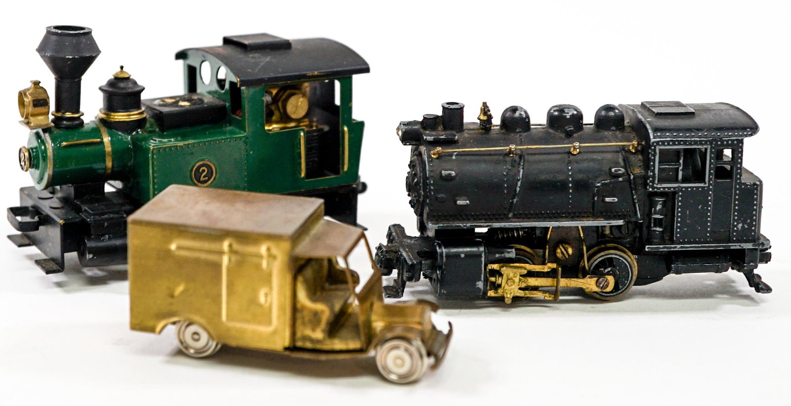 Small Metal Toy Trains (2) and Van (1): Collection of three small metal toys with wheels. Two trains and one delivery truck. Measure from 2 in. - 3 in. long. If lot is absent of a condition report one may be requested via email. Condition r