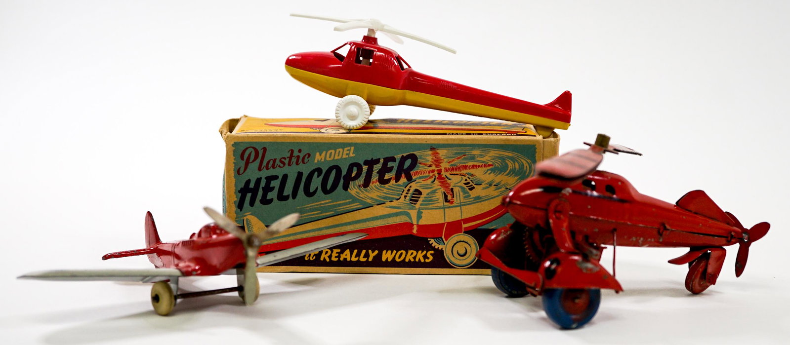 Vintage Toy Plane and Helicopter (3) One Winds: Collection of three vintage toy plane (1) and helicopters (2). British helicopter includes original box. One copter winds and has been tested, blades need adjustment and does not come with key. Measur