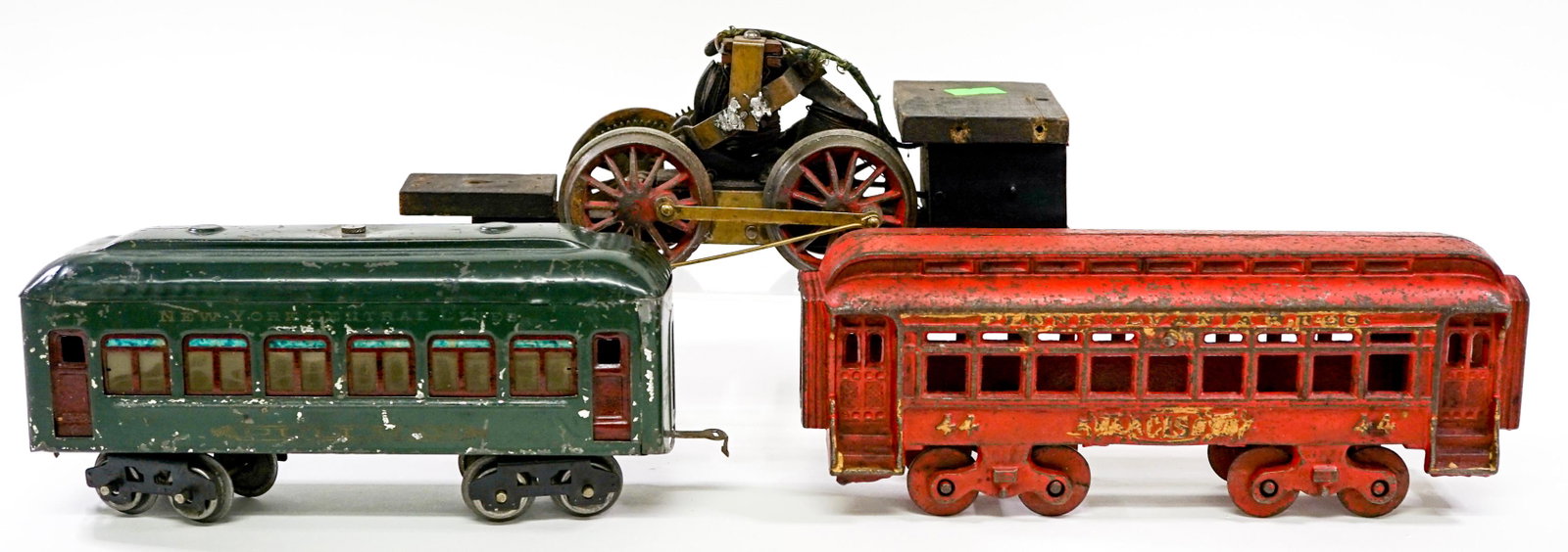 Vintage Toy Trains (3): Collection of three vintage toy trains. Not tested. Cast iron, metal and wood. Measure 8.25 in. - 10 in. long. If lot is absent of a condition report one may be requested via email. Condition report i
