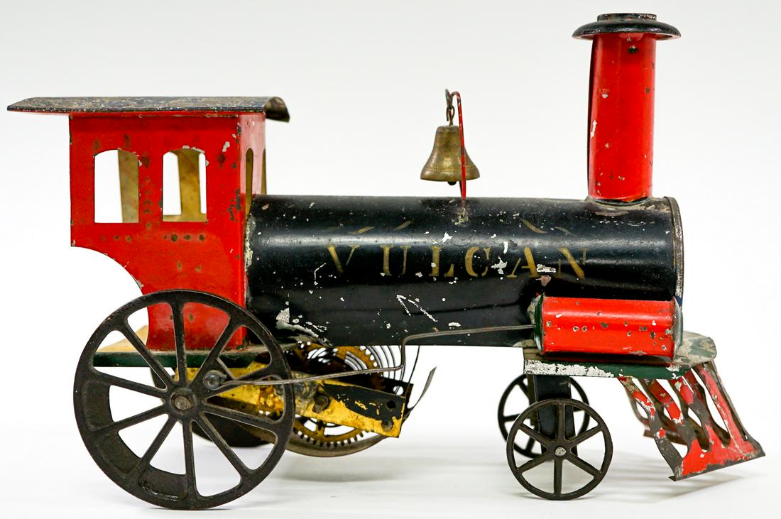 Early Vulcan Toy Train Engine AS-IS: Early Vulcan tin toy train engine. AS-IS. Measures 10 in. x 3.675 in. x 7 in. tall. If lot is absent of a condition report one may be requested via email. Condition report is provided as an opinion on