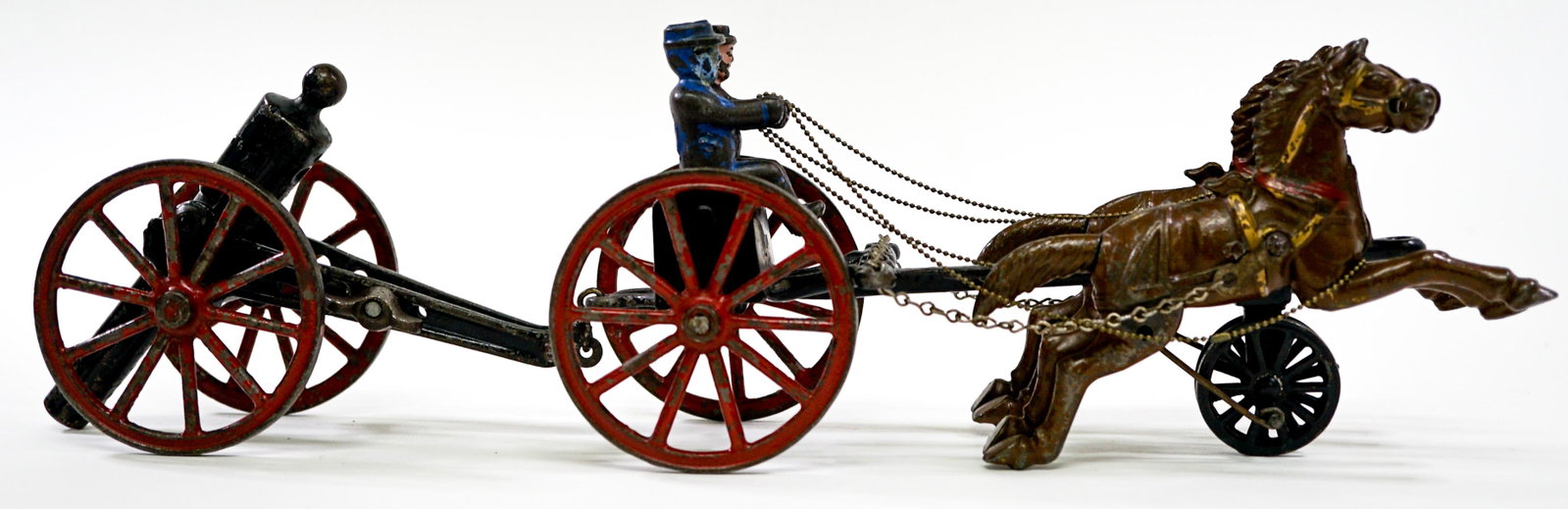 Vintage Kenton Horse Drawn Caisson Cannon Toy: Vintage Kenton horse drawn caisson with cannon. Two horses and two seated soldiers. Cast iron with original paint. Horses gallop when pulled. Measures approximately 18 in. long. If lot is absent of a 