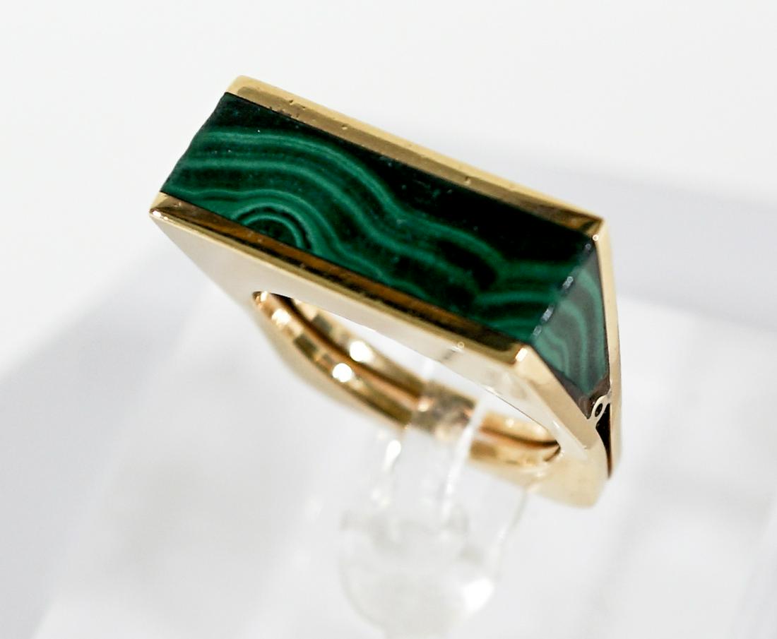 18k Gold and Malachite Designer Ring: 18k gold and malachite designer ring. Measures 1-in. x .8125-in. x .375-in., ring size 7and weighs 13 grams. This lot requires a Wire or Zelle transfer. If lot is absent of a condition report one may