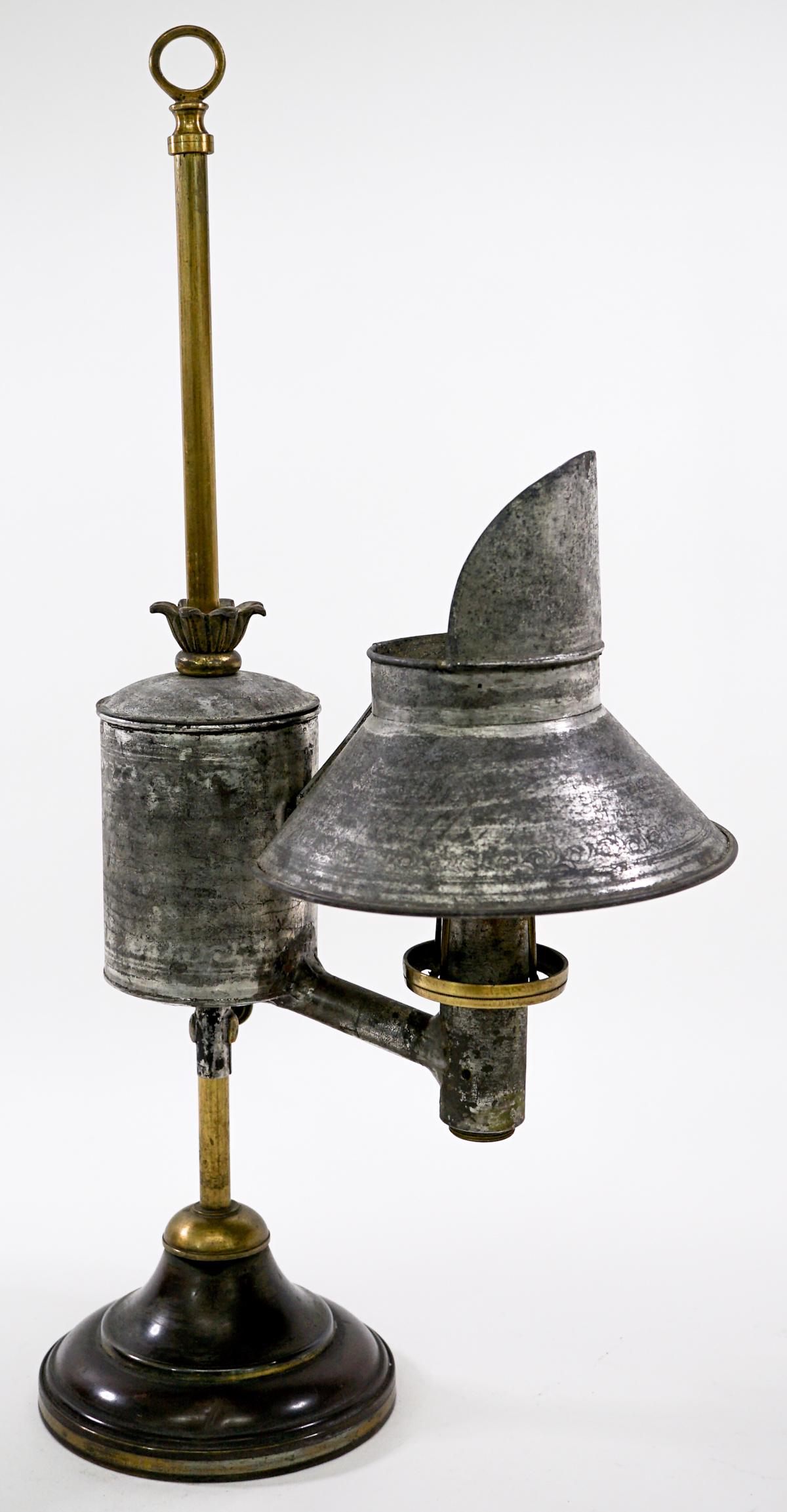 Vintage Tin Betty Oil Lamp: Vintage Tin Betty oil lamp. Measures 5 in. across base and is 21 in. tall and 11 in. wide. Weighs 5 lbs 5 oz. Provenance: From the estate of Clint Max Miller of Seattle and most recently Walla Walla.