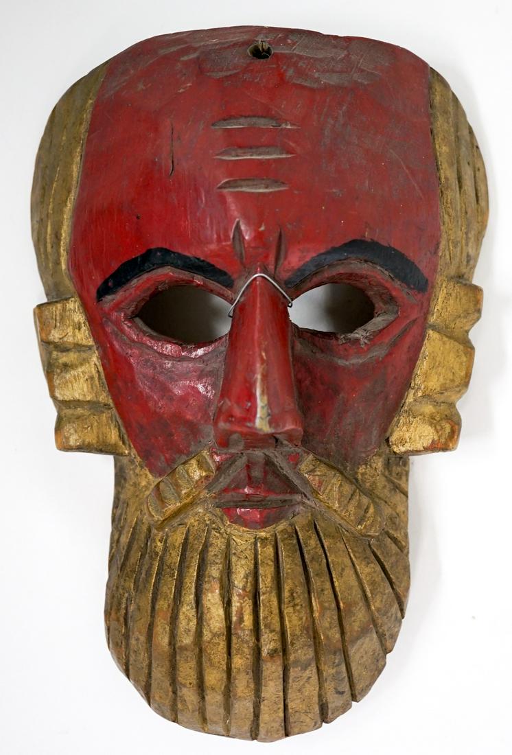Vintage Wood Carved Mask Painted: Vintage wood carved mask with gilt, red and black paint. Measures 9.75 in. x 6 in. x 3 in. Weighs 11 oz. If lot is absent of a condition report one may be requested via email. Condition report is prov
