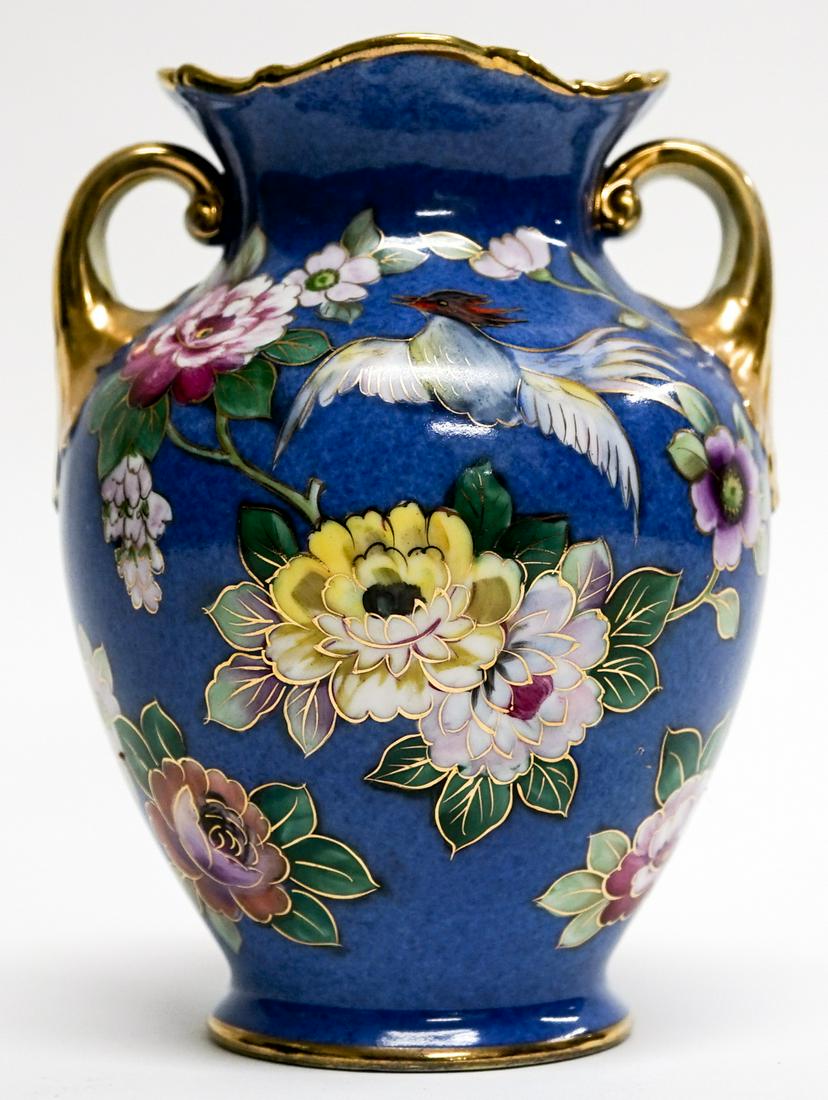 Noritake Urn Handpainted Japan [Floral]: Noritake urn with scrolled handles and floral pattern. Hand-painted. Made in Japan. Measures 6.5 in. tall x 5 in. wide. Weighs 1 lb 1 oz. If lot is absent of a condition report one may be requested vi