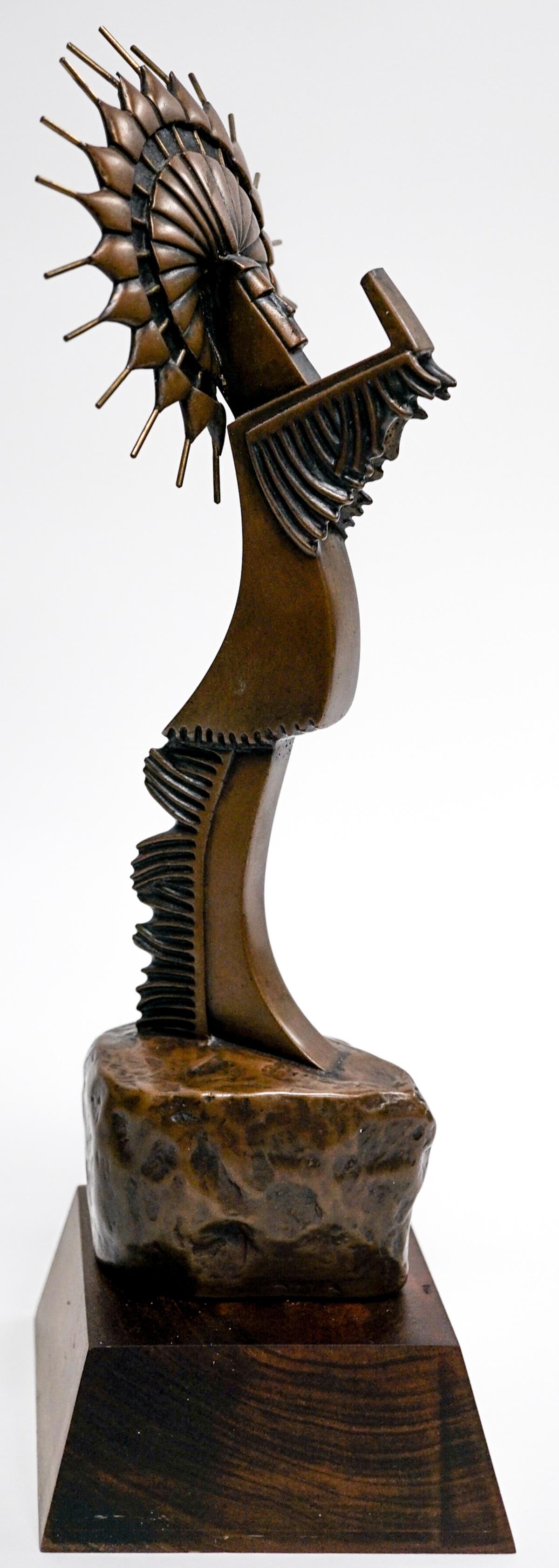 A Signed Bronze: A signed bronze as-is. Upon further inspection the item that the figure is holding appears to have been broken and the piece is lacking. Measures 12 inches tall and stands on a wood base. Provenance: 