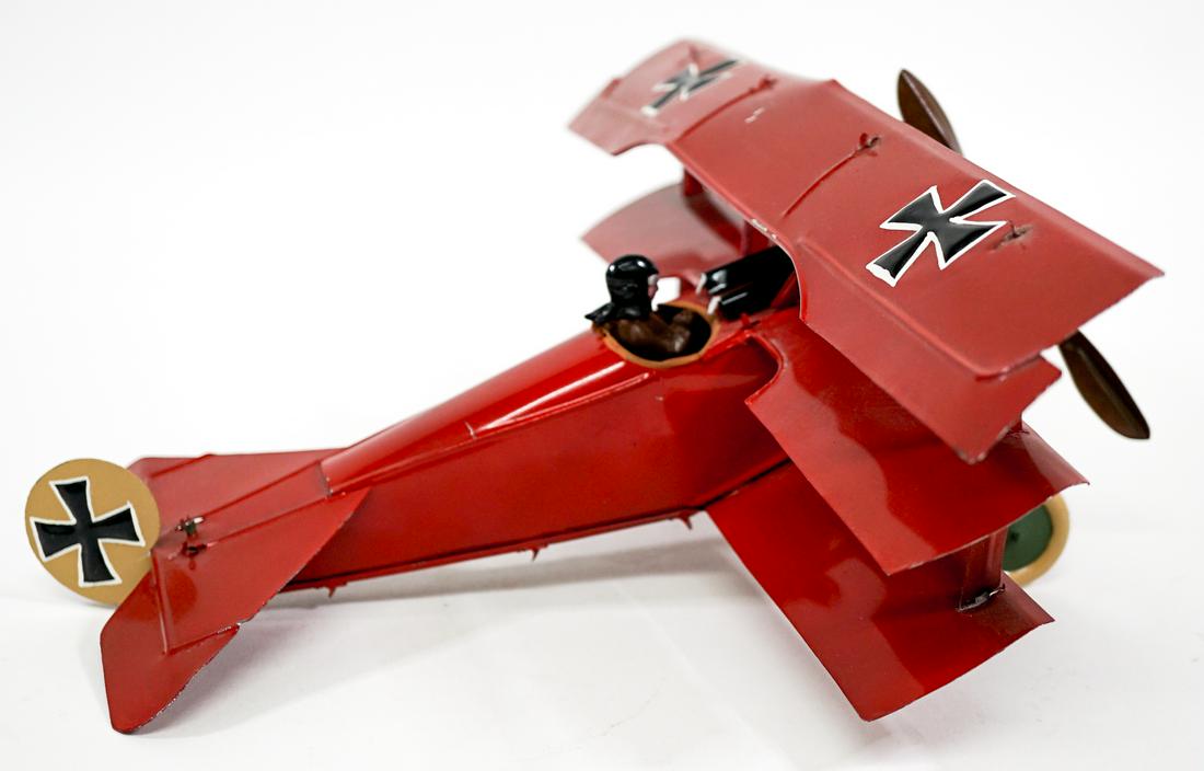 Vintage Tin Toy Fighter Plane: Vintage tin toy fighter plane. Initialed on the underside. Measures 10 in. long x 13 in. wide x 5 in. tall. Provenance: From the estate of Clint Max Miller of Seattle and most recently Walla Walla. Cl