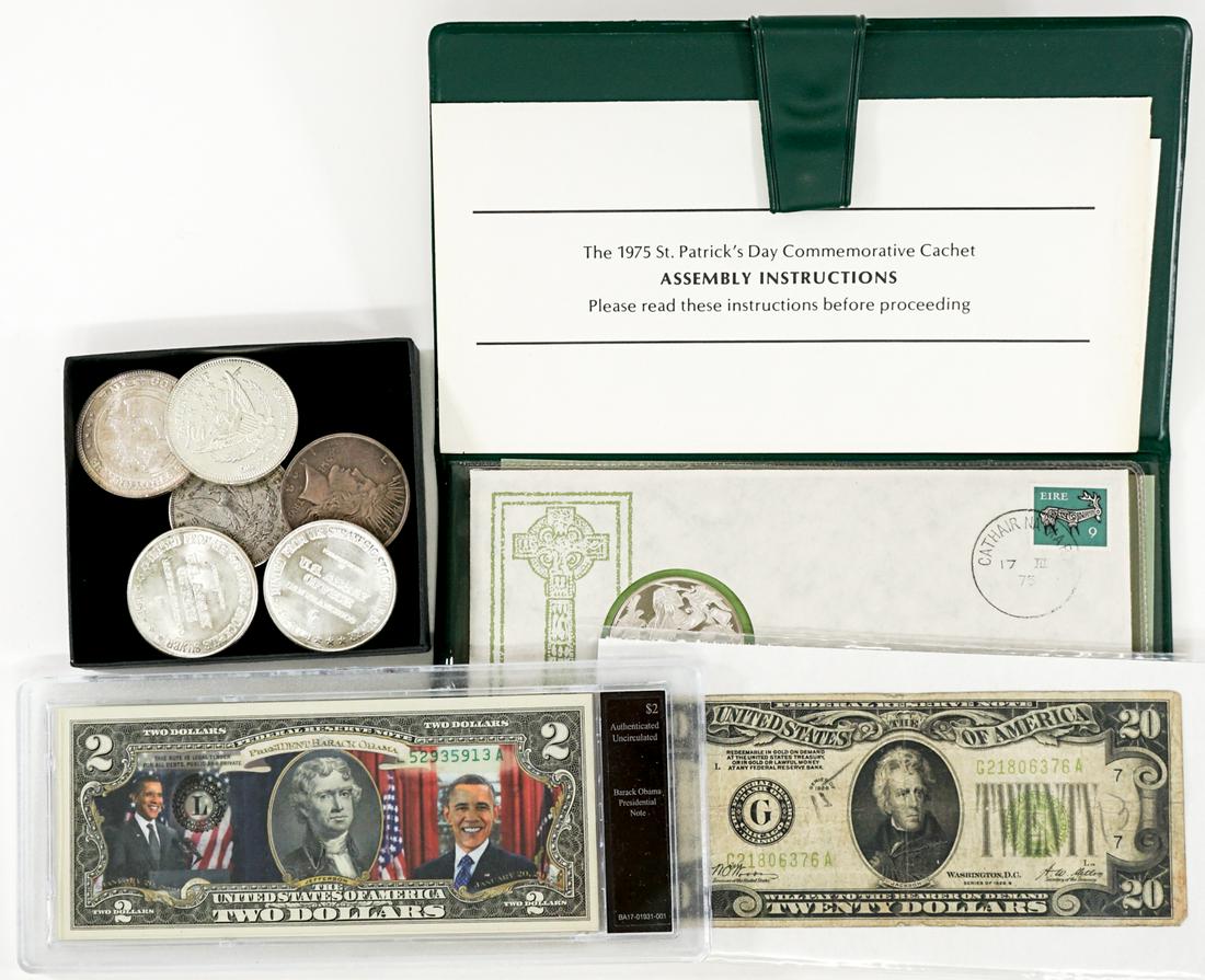 U.S. Coins, Currency and Bullion: An estate group of currency, coins and bullion. Includes Series of 1928 $20 bill, Obama $2 bill, two U.S. silver dollars, 1975 St. Patrick's Day silver round and four .999 one ounce silver rounds. Thi
