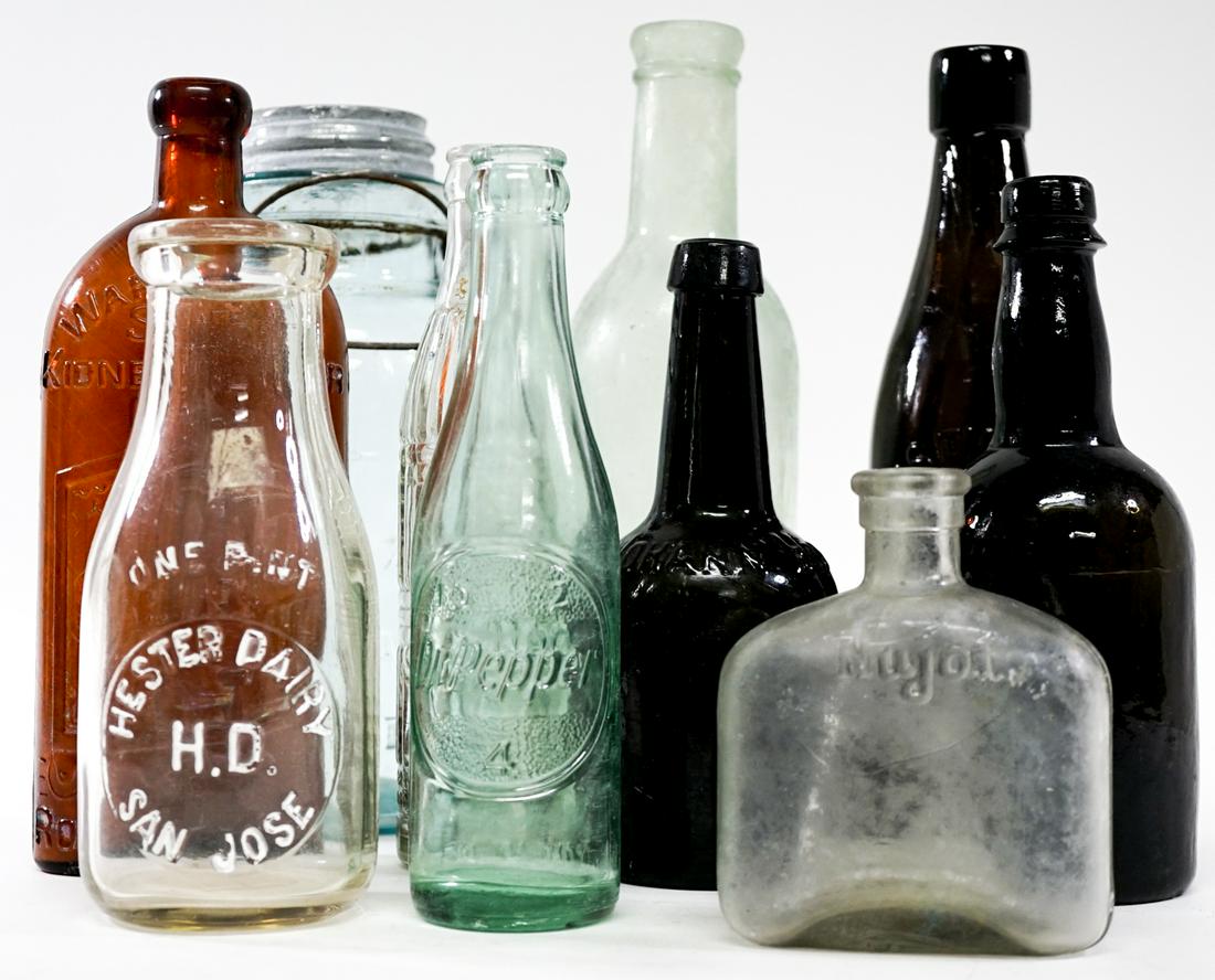 Vintage (10) Glass Bottles: Ten (10) vintage glass bottles. Measure 4.75 in. - 10.5 in. tall and 2 in. - 4.75 in. across bases. Weighs 12 lbs. If lot is absent of a condition report one may be requested via email. Condition repo