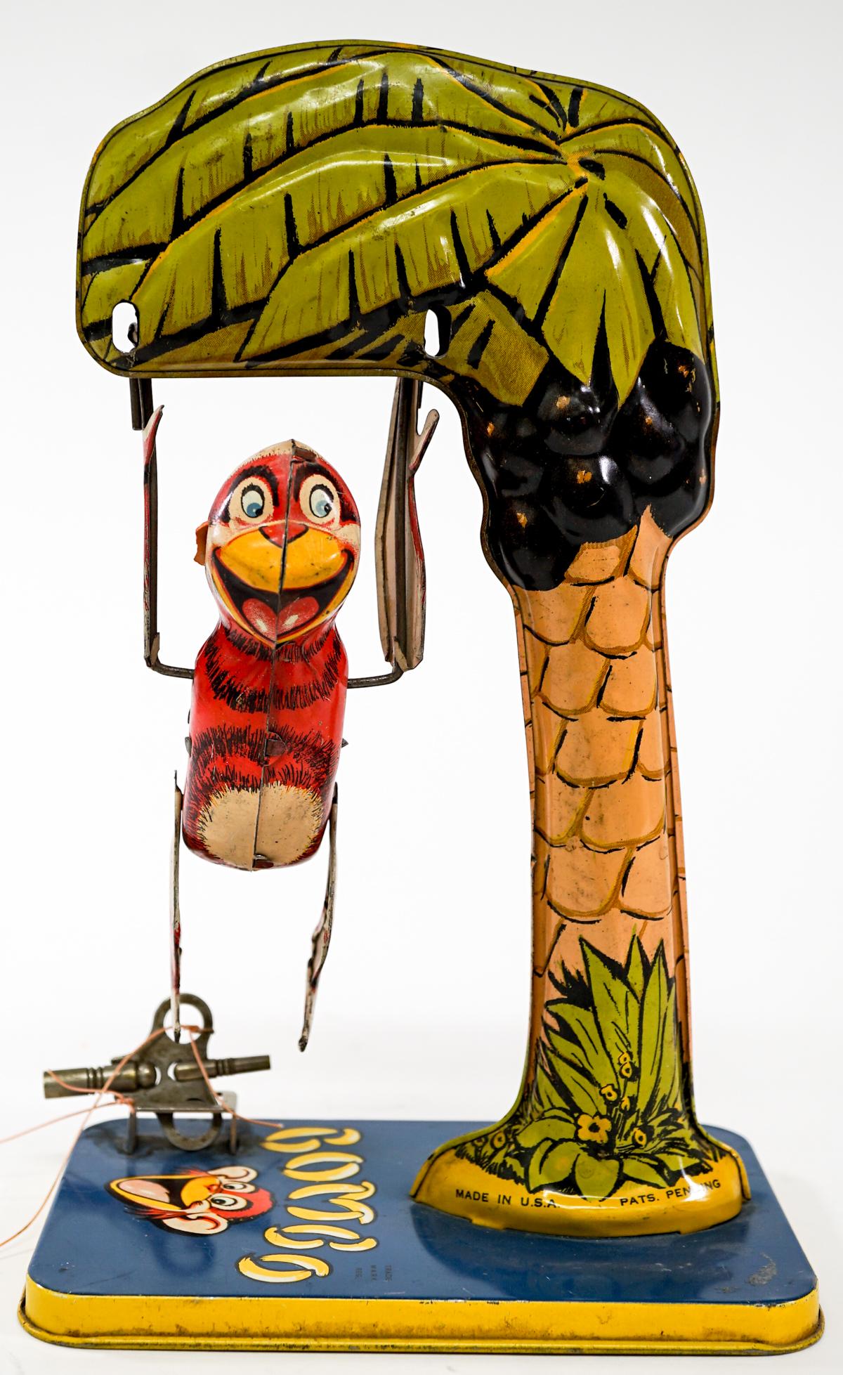 Vintage Bombo Tin Litho Wind-Up: Vintage Bombo the Chimp tin litho wind-up toy. Tested and works. Measures 9 in. tall. Provenance: William Emery Collection, Sheridan Wyoming. If lot is absent of a condition report one may be requeste
