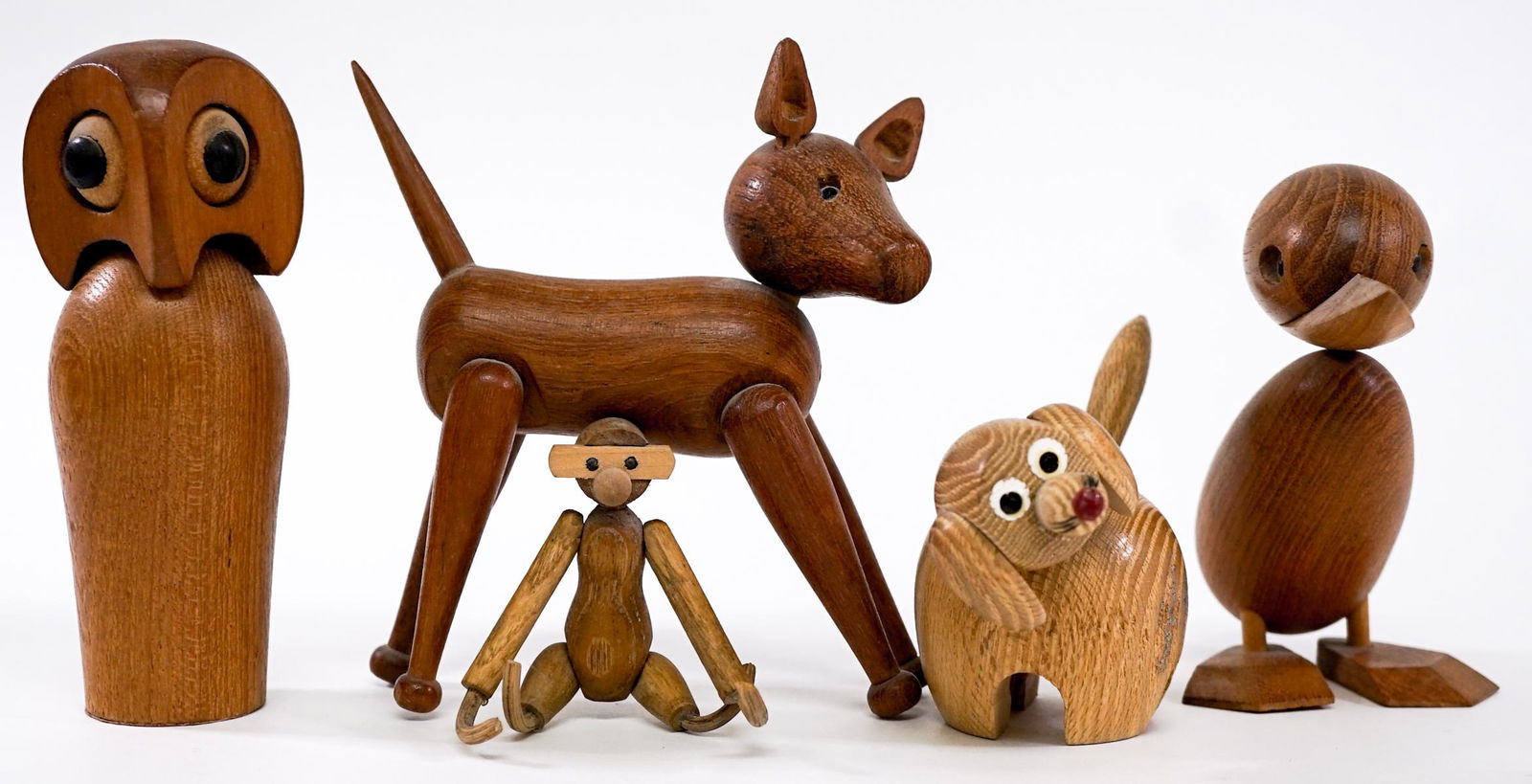 Mid Century Teak Animals (5) [Owl, Duck , Dog]: Mid Century Teak animals Kay Bojesen style. Includes: Owl; Duck; Monkey; and Dogs. Measure from 3.5 in. - 5 in. tall. If lot is absent of a condition report one may be requested via email. Condition r