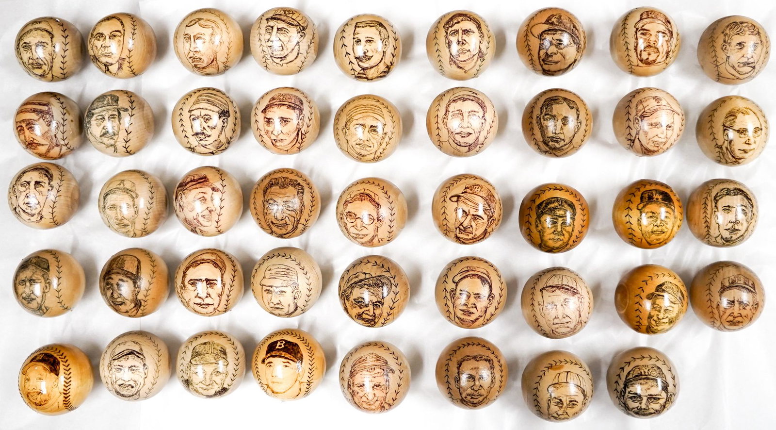 Hall of Famers Pyrographic Baseballs (44): A collection of (44) pyrographic wood baseballs of past Hall of Famers. This lot includes Cy Young, George Sisler, Mike Piazza, Lefty Grove, Ernie Lombardi , Mickey Cochrane, Christy Mathewson, Joe Ti