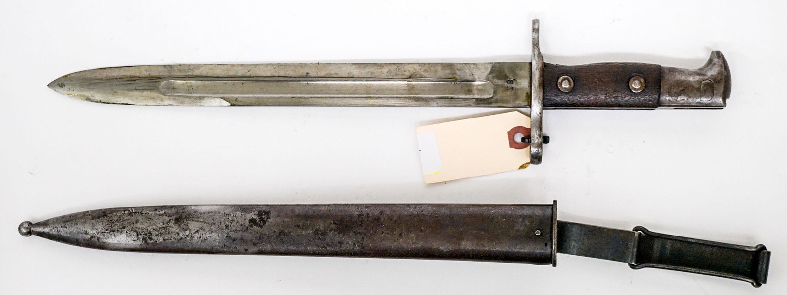 U.S 1899 Bayonet and Scabbard: U.S. 1899 bayonet and scabbard. Measures 17.25-in. If lot is absent of a condition report one may be requested via email. Condition report is provided as an opinion only and is no guarantee as grading