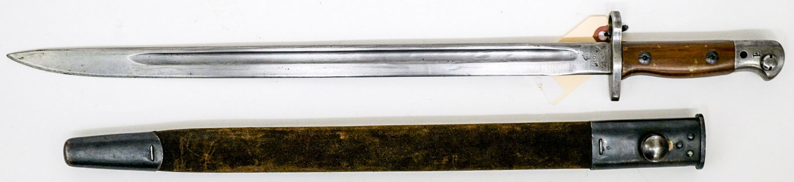 1907 Wilkinson British Bayonet and Scabbard: 1907 Wilkinson British Bayonet and Scabbard. Measures 22.625-in. If lot is absent of a condition report one may be requested via email. Condition report is provided as an opinion only and is no guaran