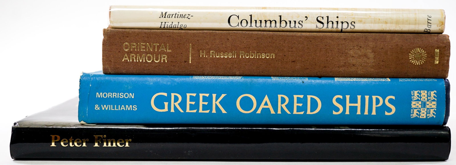 Ships and Armor (4) Illustrated Books: Four (4) illustrated books of ships and armor. Includes: 1) Greek Oared Ships 900-322 B. C. 1968 with unclipped dust jacket. Cambridge. Lower edge of covers with wear. Dust jacket worn at edges with c