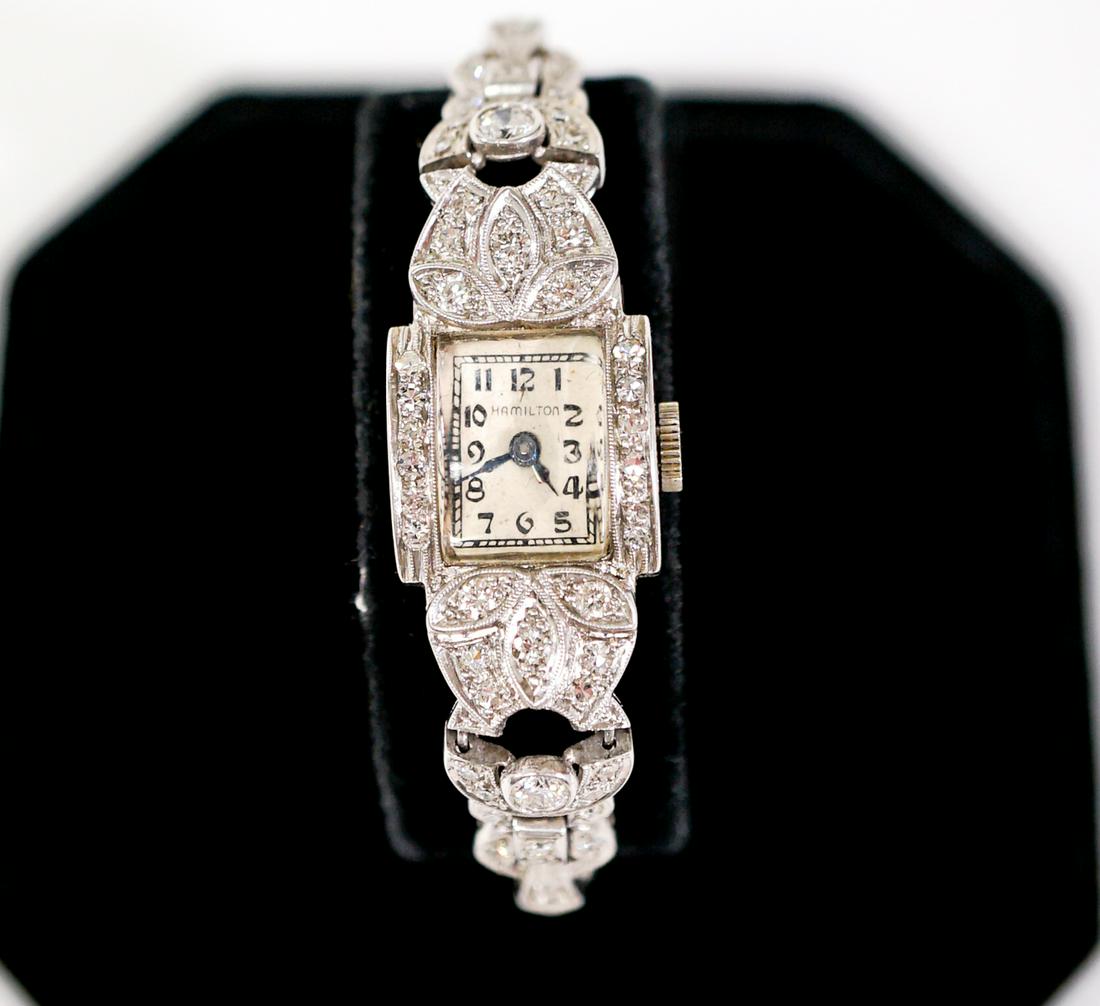 Lady's Platinum and Diamond Hamilton Wrist Watch: Lady's Platinum and Diamond Hamilton Wrist Watch. The Watch has a seventeen jewel 911 movement in a 19.2mm x 14.2mm rectangular case and champagne dial with blue sword hands. The Watch has seventeen r