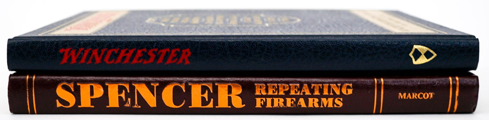 Firearm (2) Books [Spencer; Winchester]: Two (2) firearm books. Includes: 1) Spencer Repeating Arms by R. M. Marcot. 1983. 2) Winchester Repeating Arms reprint 1995 with foreword by George A. Hoyem. Measure approximately 11.25 in. x 8.75 in.
