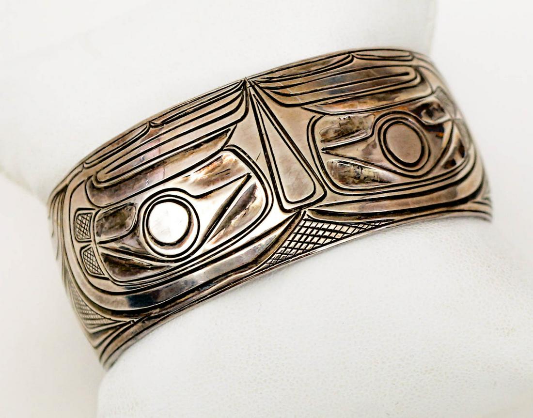Northwest Coast AMOS WALLACE Raven Bracelet: Northwest Coast AMOS WALLACE Sterling Silver Raven Cuff Bracelet. Measures 1 inch in width x 2.375 inches x 2.25 inches. Inside measures 6 in. Gap measures 1.25 in. Weighs 40.5 grams. Like-new conditi