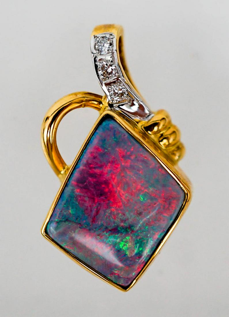 Lightning Ridge 18k Gold Bezel Set Opal Pendant: 18k Yellow Gold Bezel Set Fine Quality Solid Opal and Diamond Pendant. Like-new condition. Origin: Lightning Ridge. Colour: Red, Orange, Blue, Green. Pattern: Broad Flash. Shape: Irregular. Size 13 mm